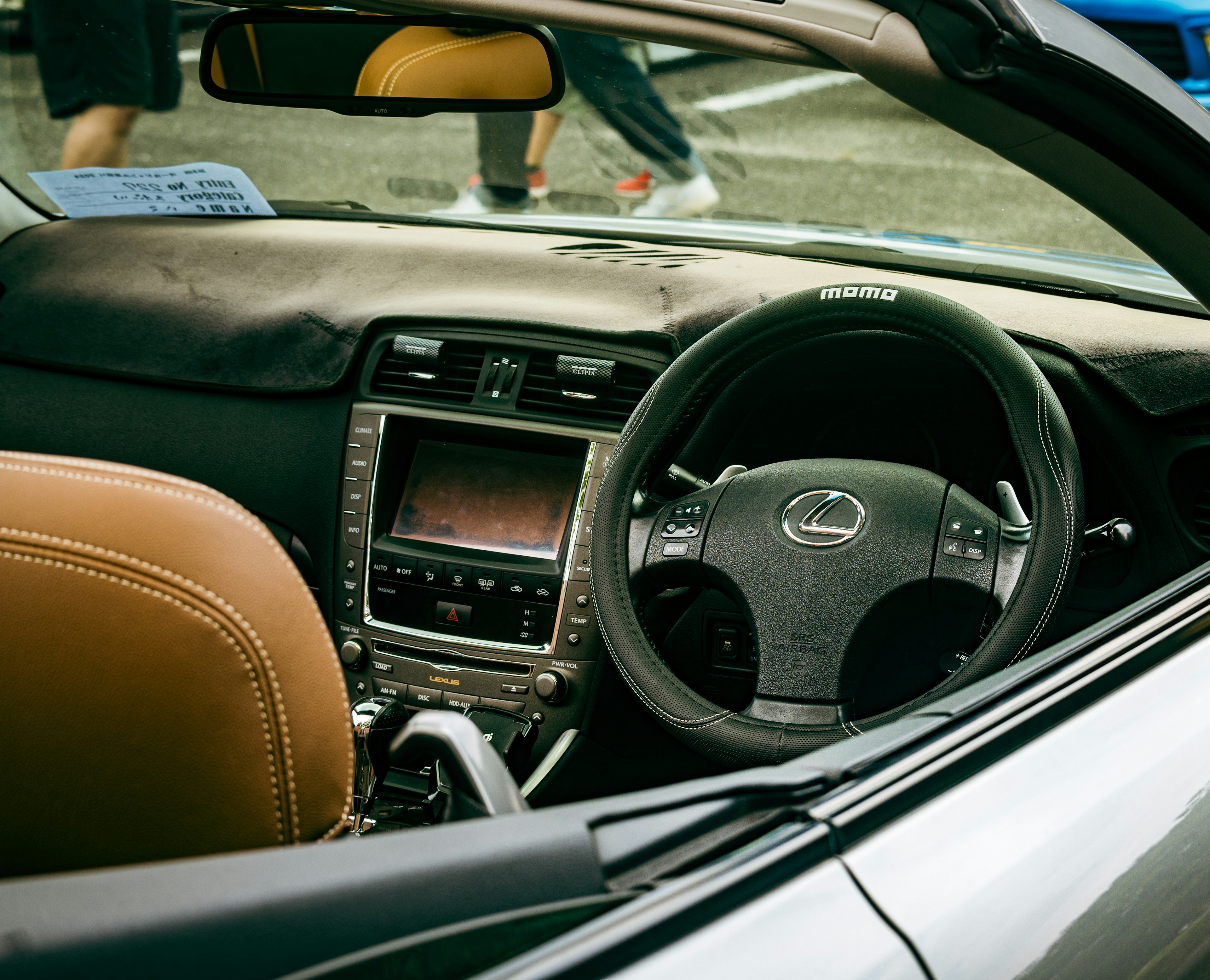 Car interior featuring leather seats, steering wheel, dashboard, sports car design