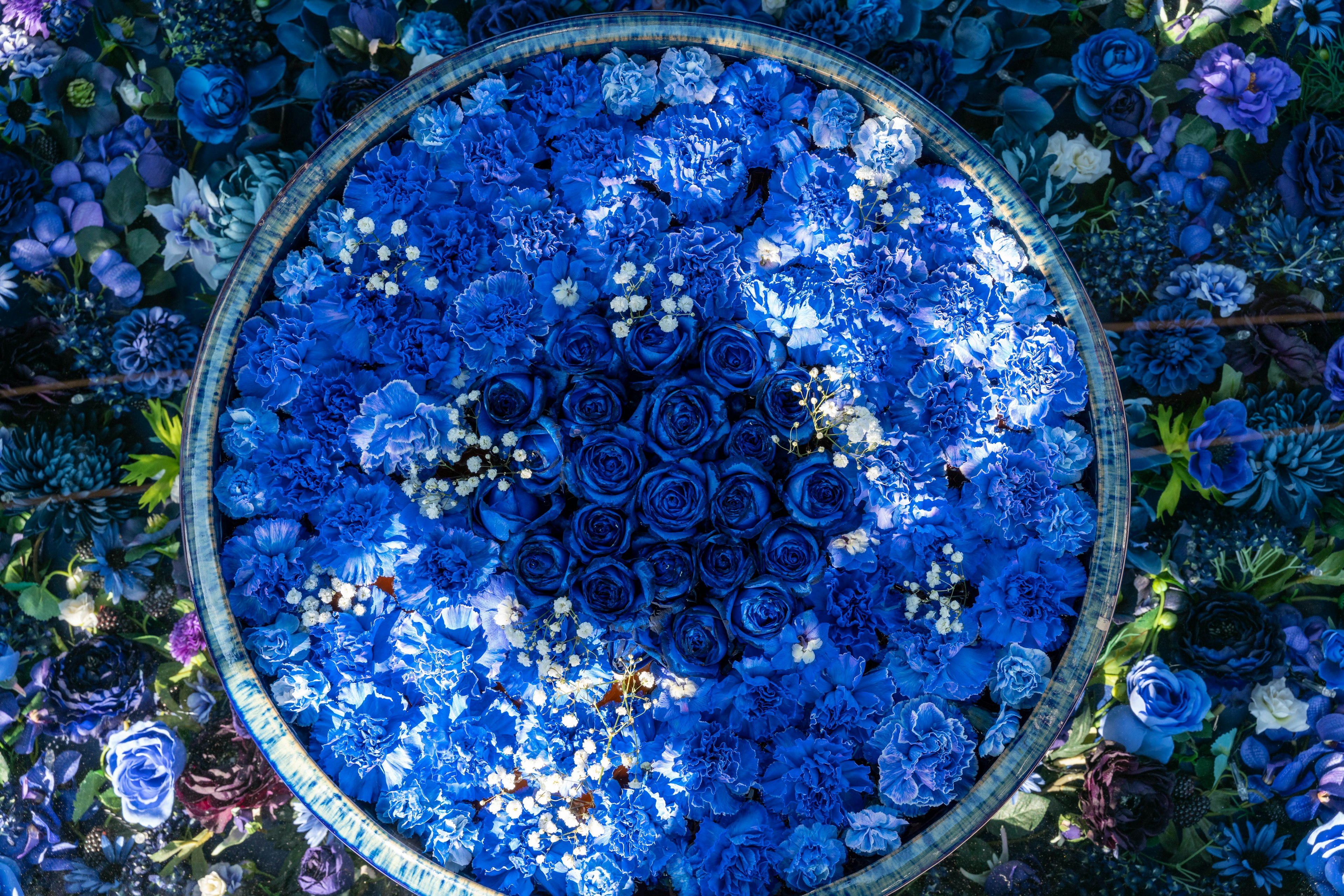 Circular arrangement of blue flowers with various shades and textures