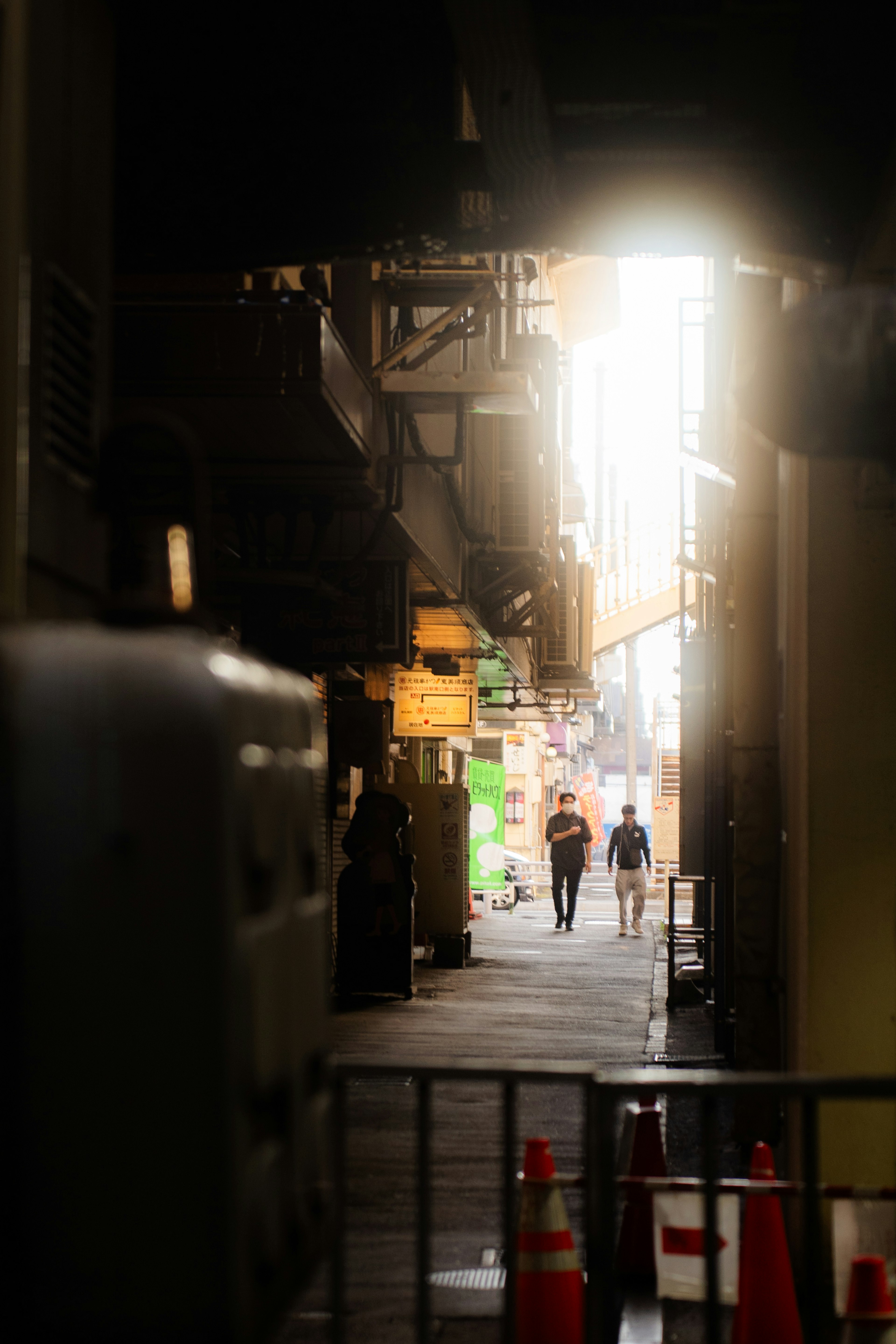 Narrow alley with people walking illuminated by soft light