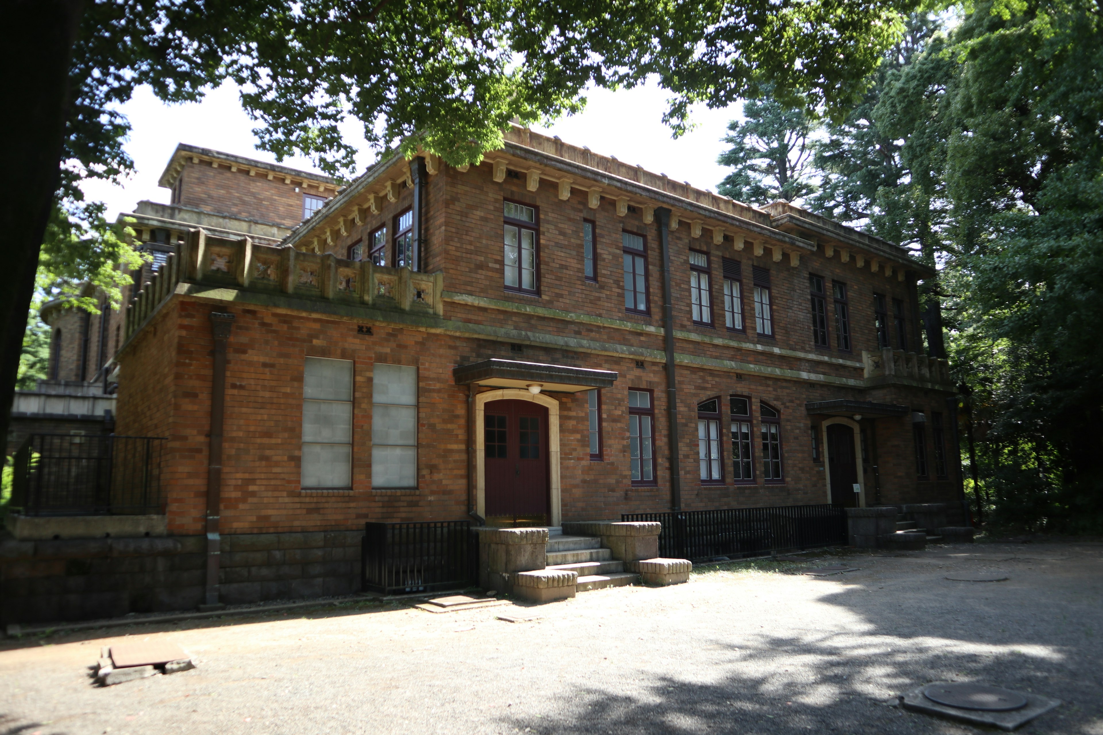 Historic brick building surrounded by greenery