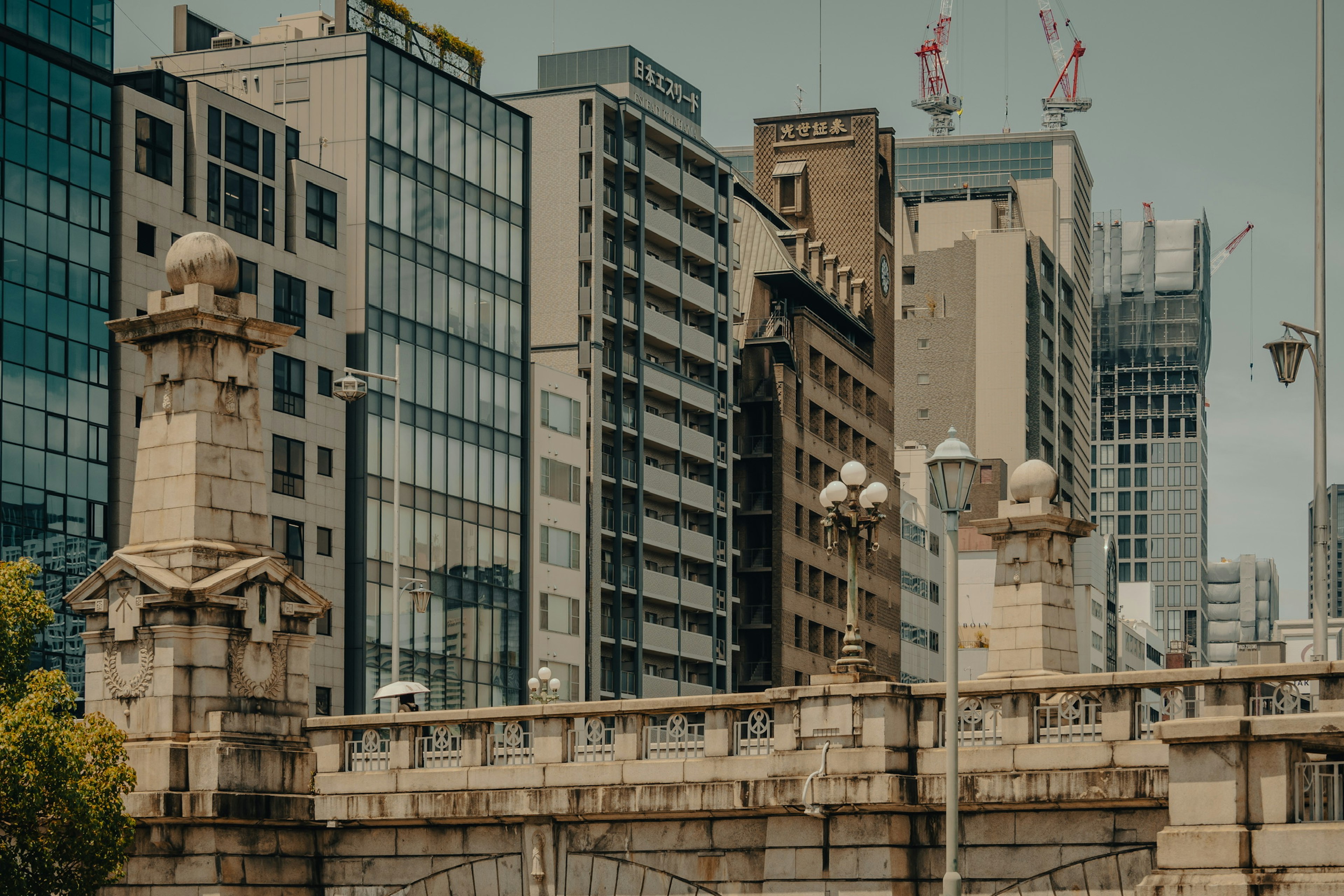 Urban landscape showing contrast between modern buildings and a historic bridge