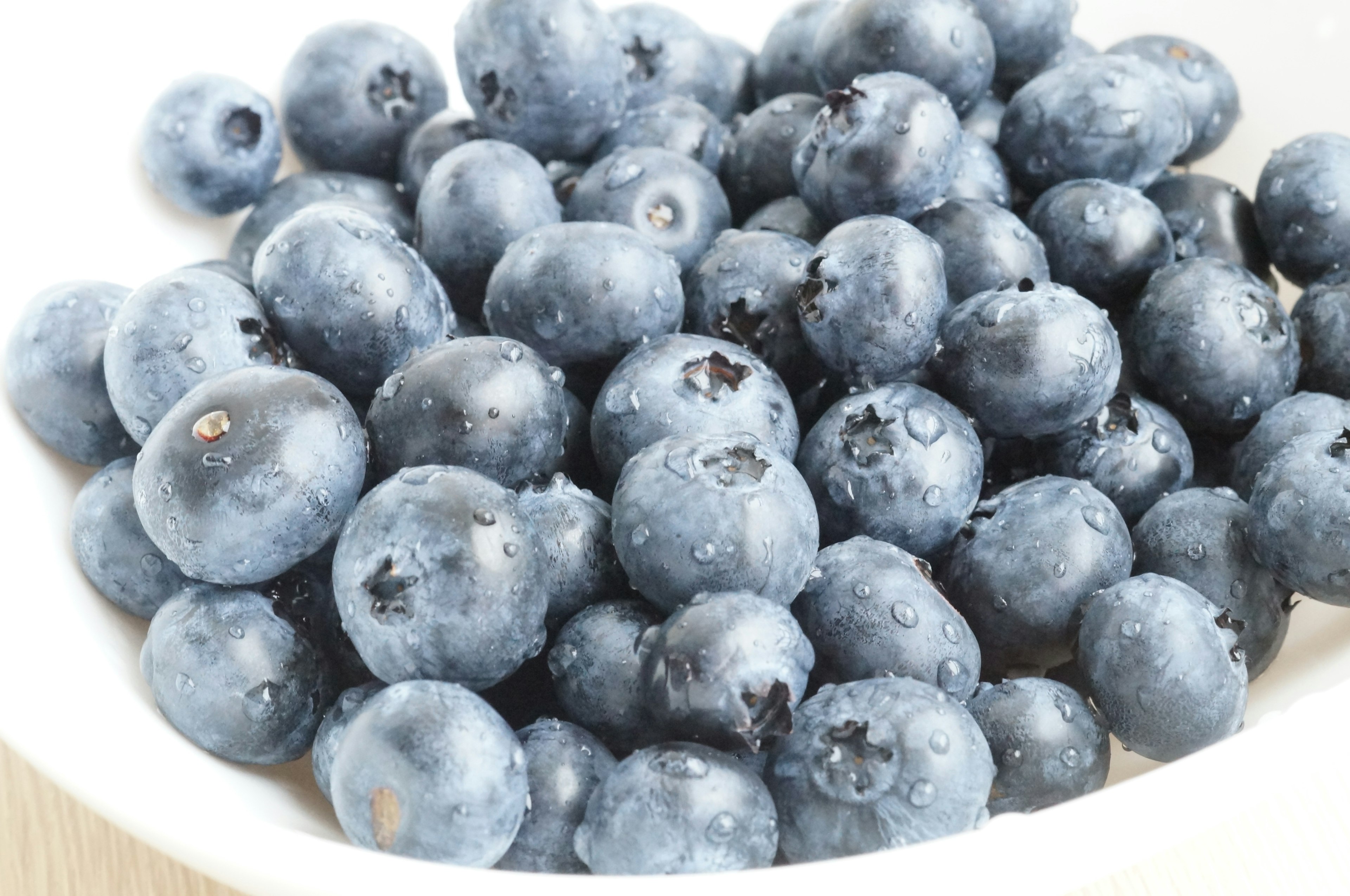 Fresh blueberries piled in a white bowl