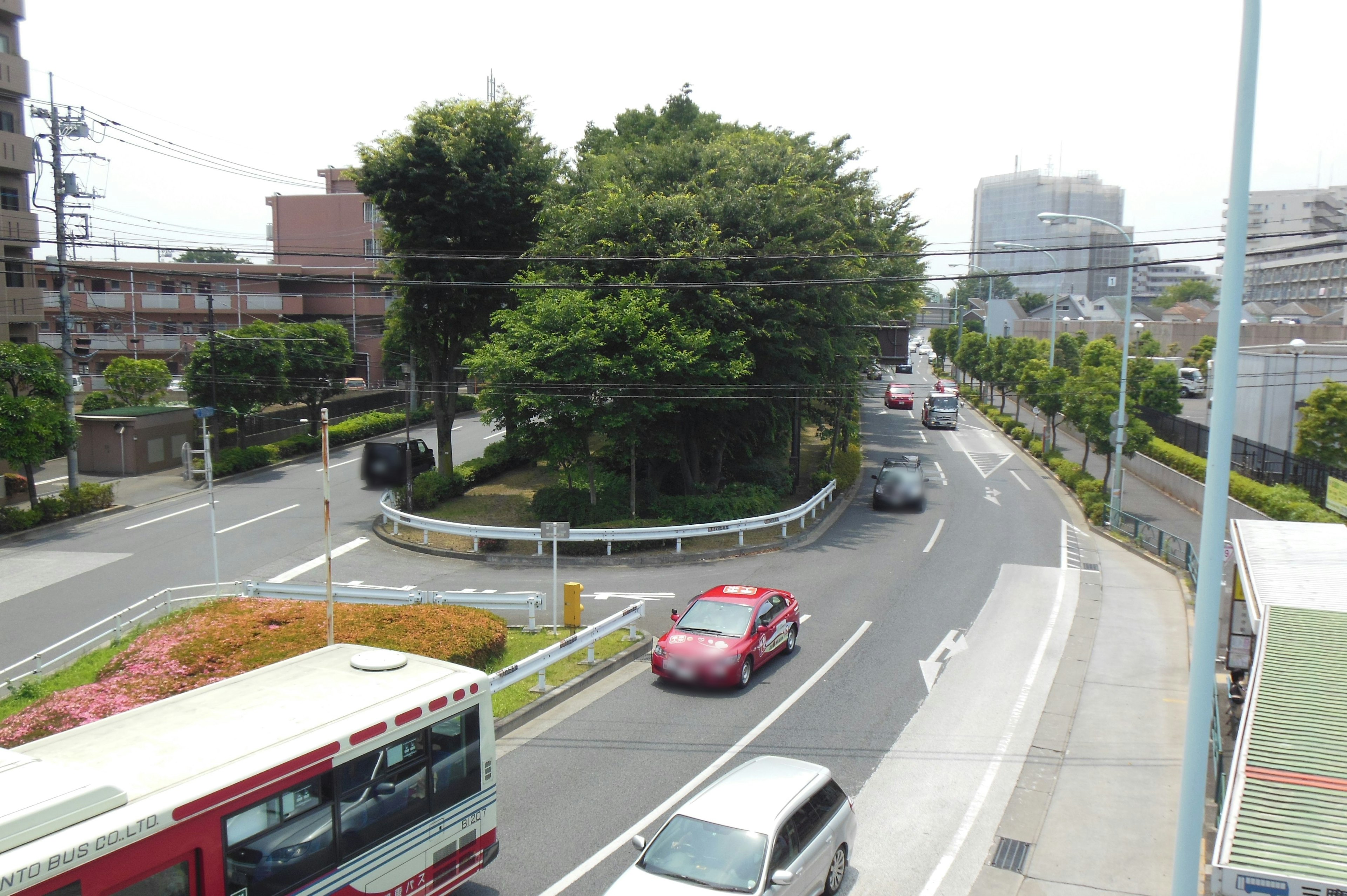 A view of a winding road with vehicles and lush greenery