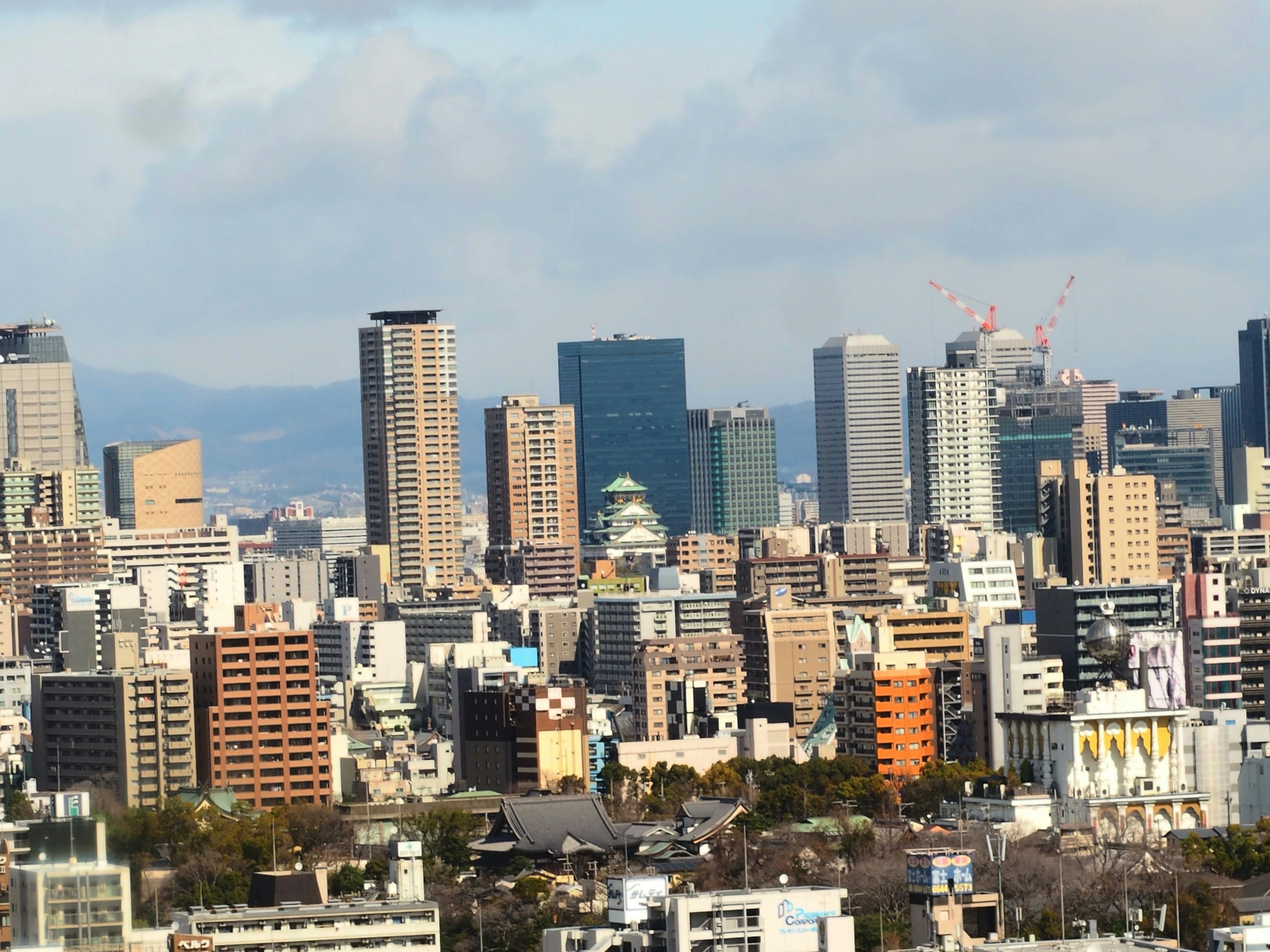 Cityscape of Nagoya featuring skyscrapers and a cloudy sky