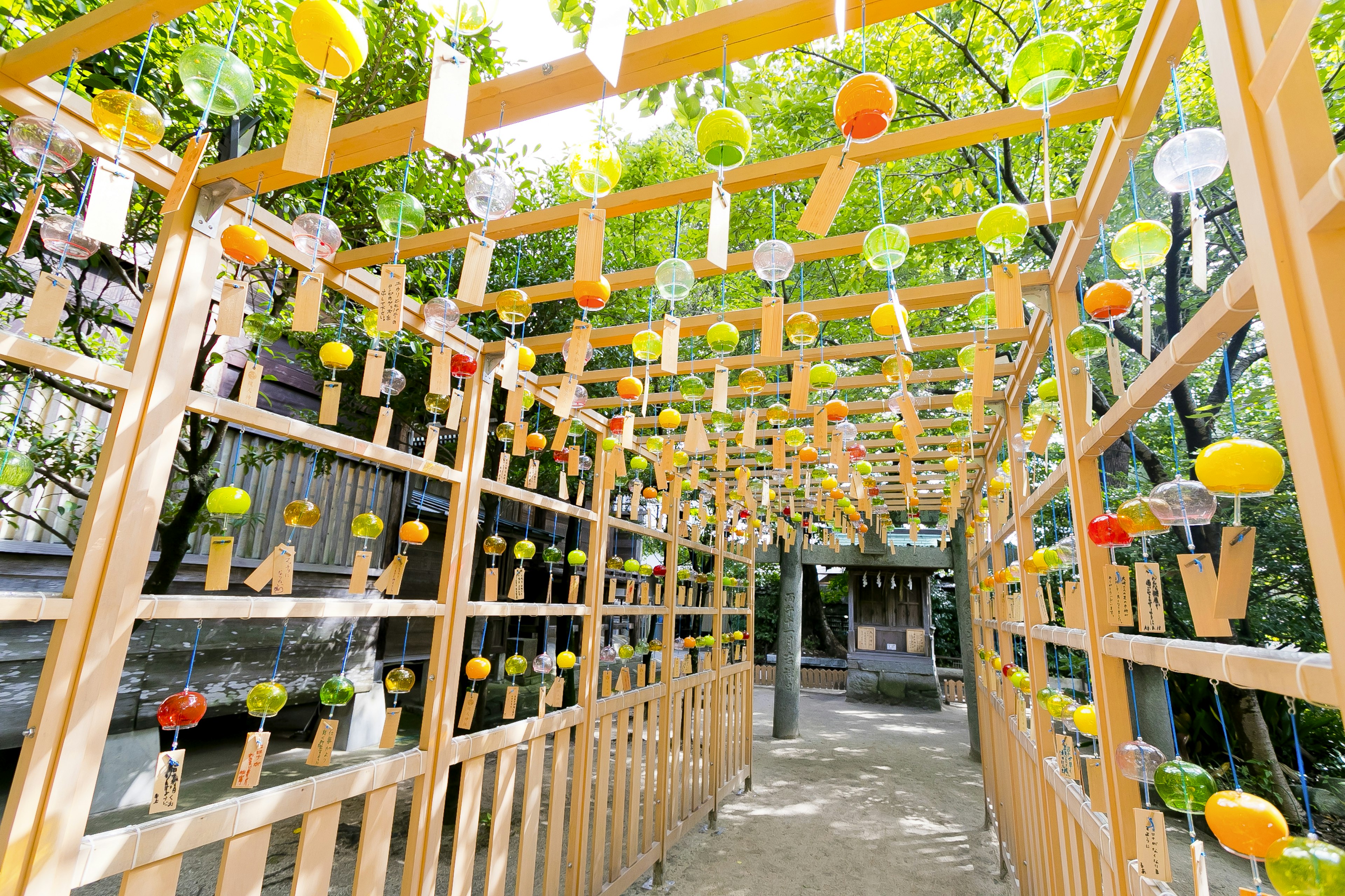 Wooden archway adorned with colorful wind chimes