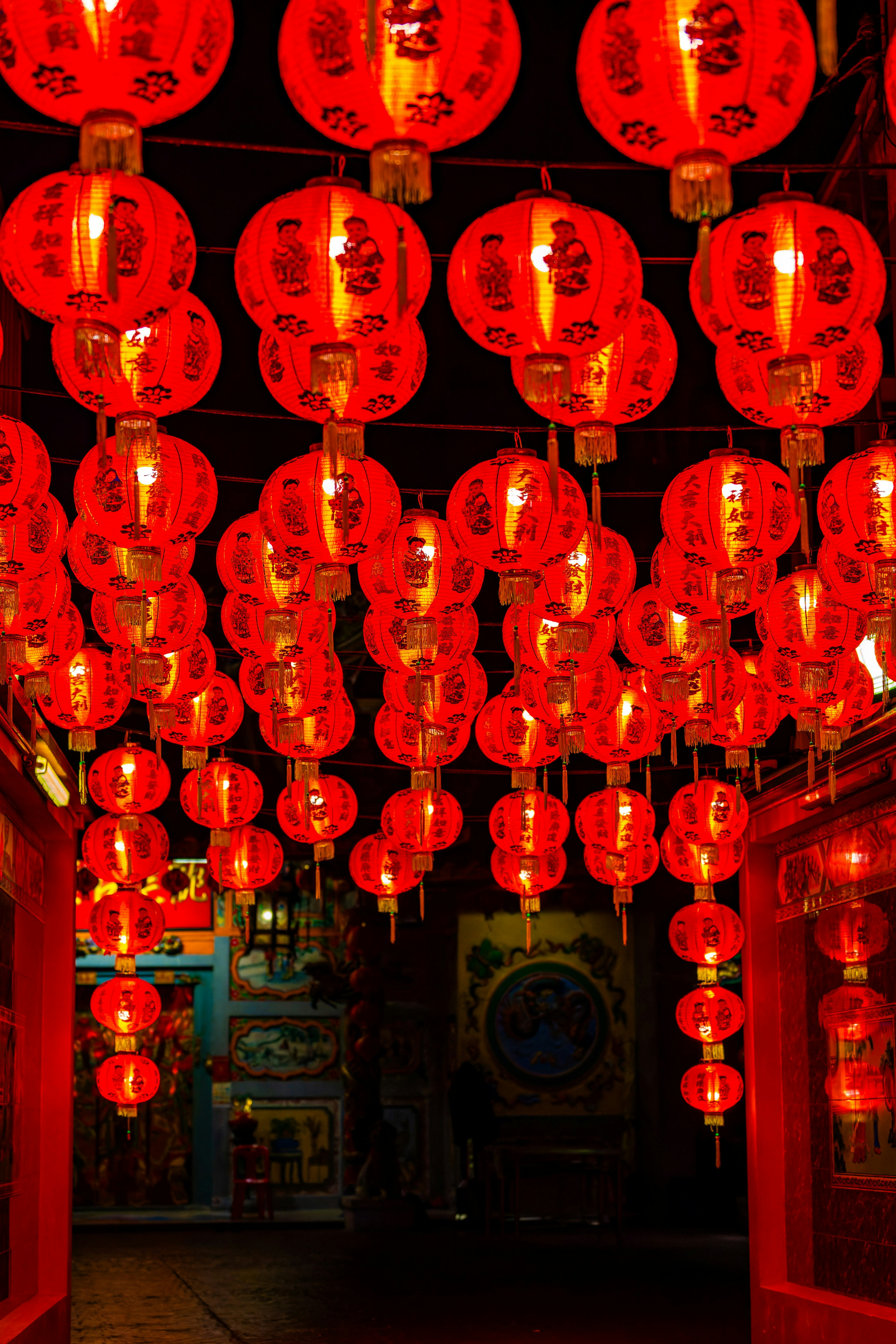 A view of a dark alley adorned with hanging red lanterns