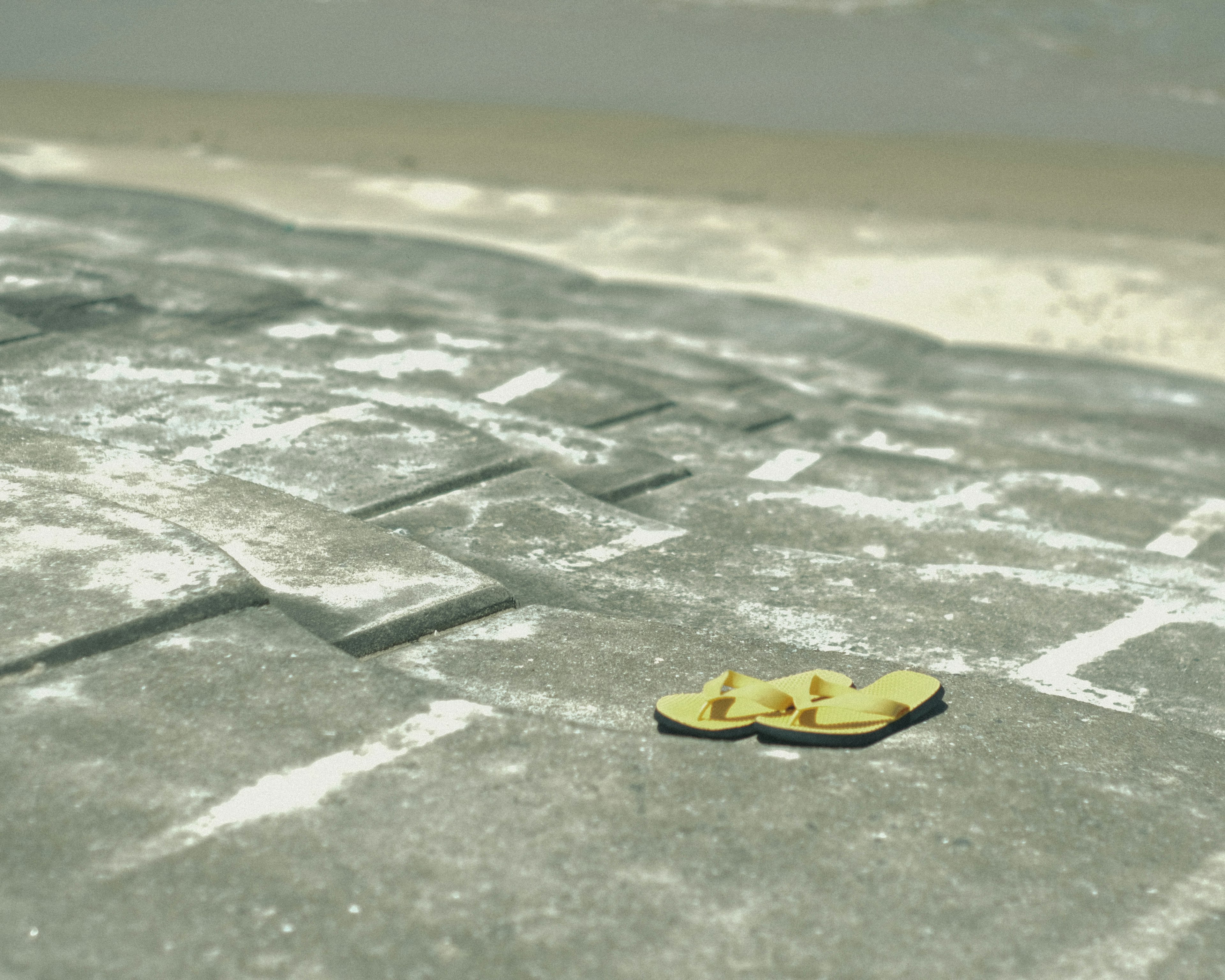 Yellow object placed on a gray surface with a textured background