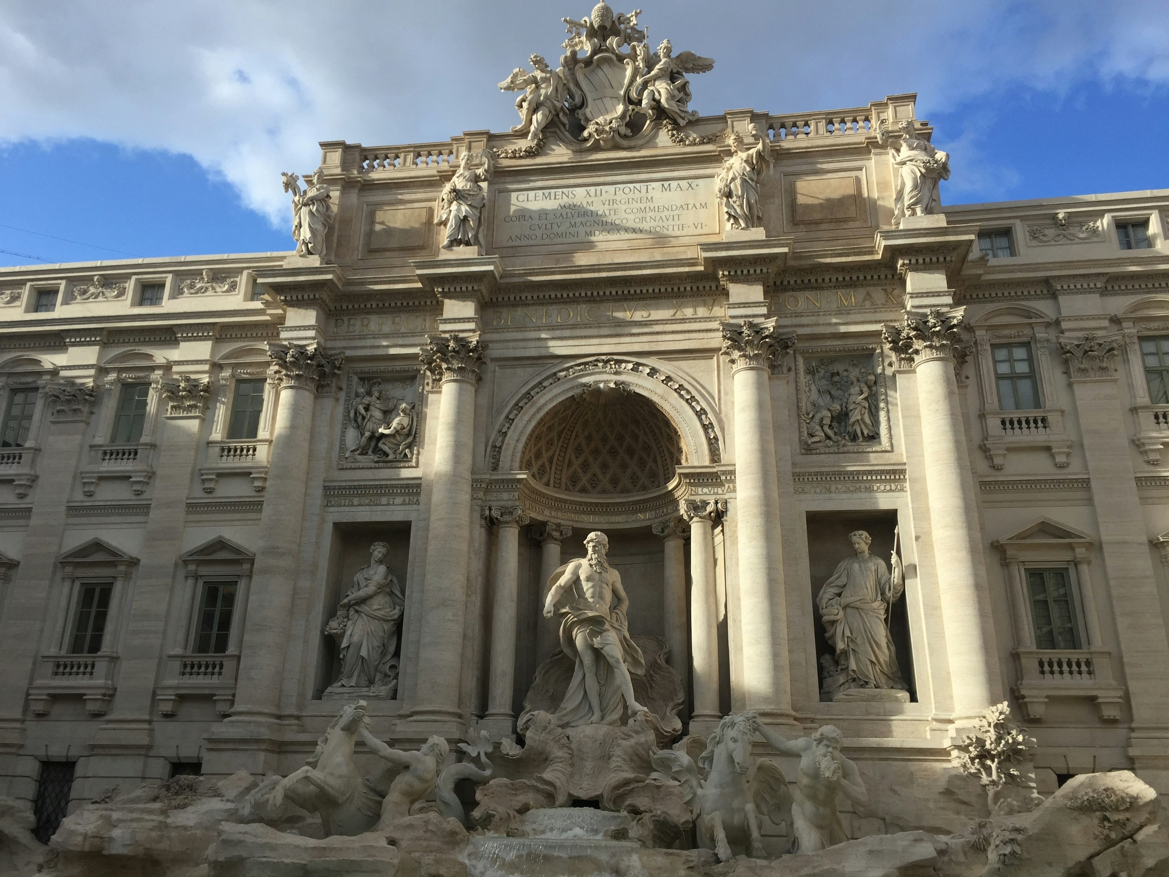 The grand facade and sculptures of the Trevi Fountain