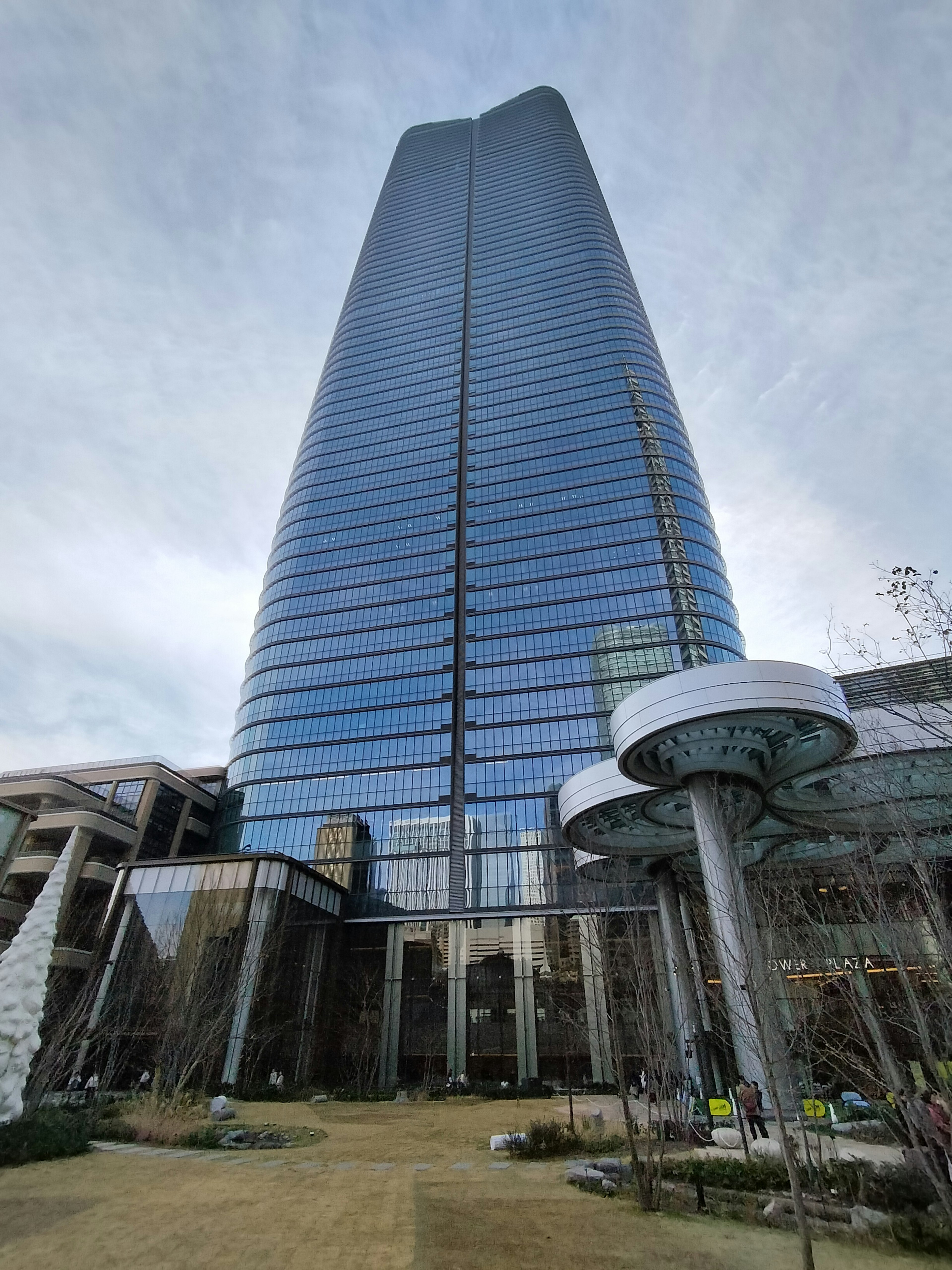 Close-up view of a skyscraper with surrounding greenery