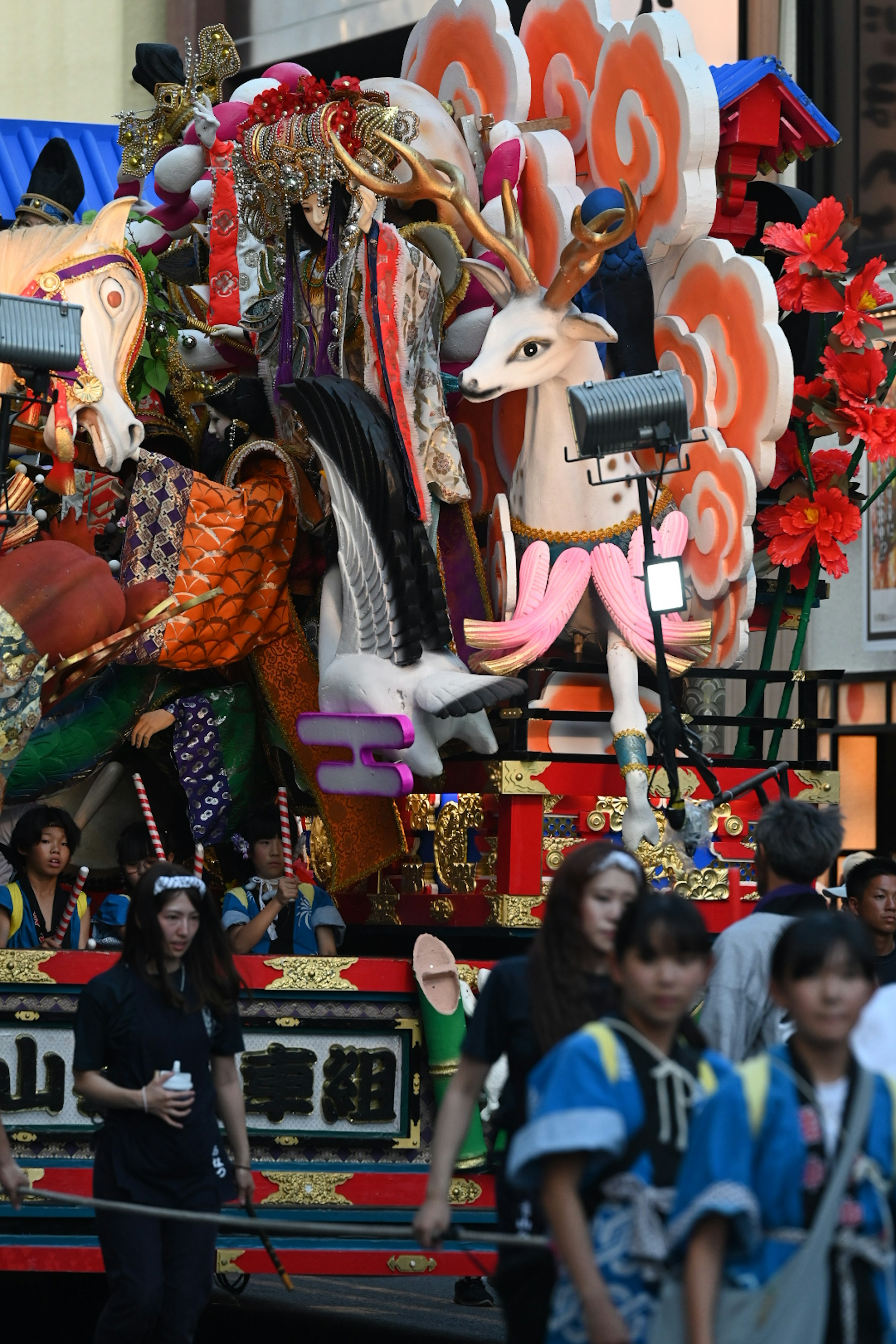 Colorful festival float featuring ornate figures and floral decorations