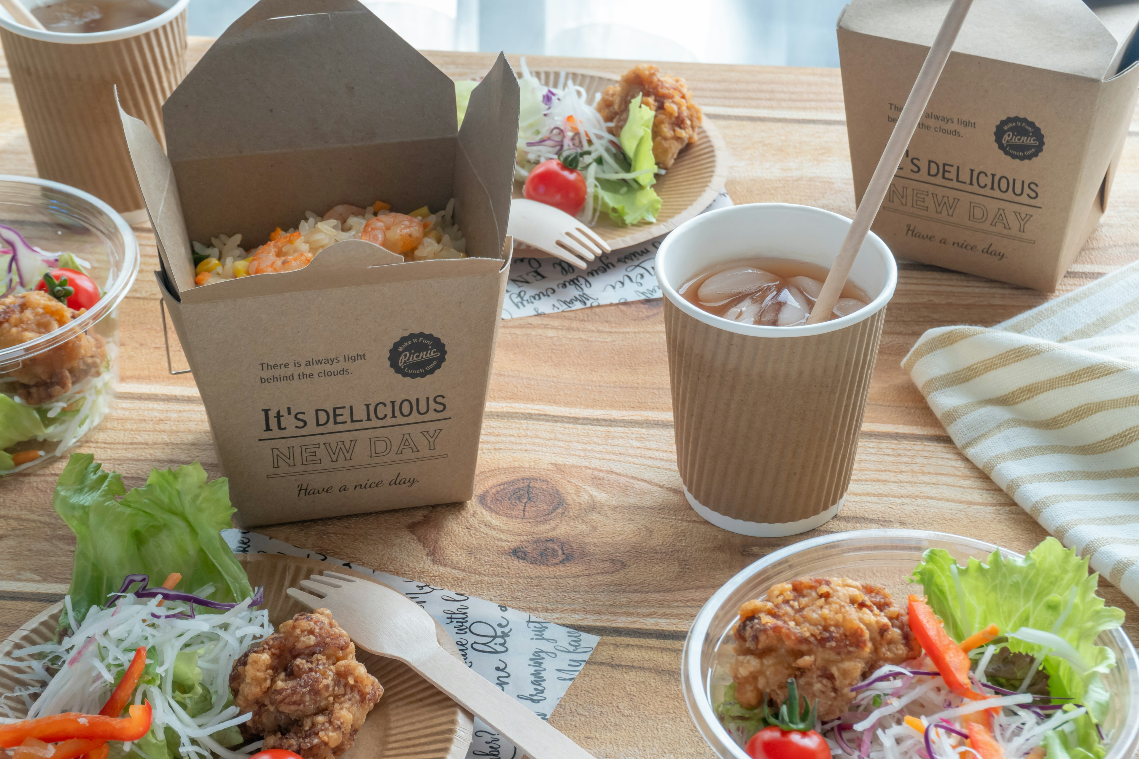 Various food containers and salads arranged on a table