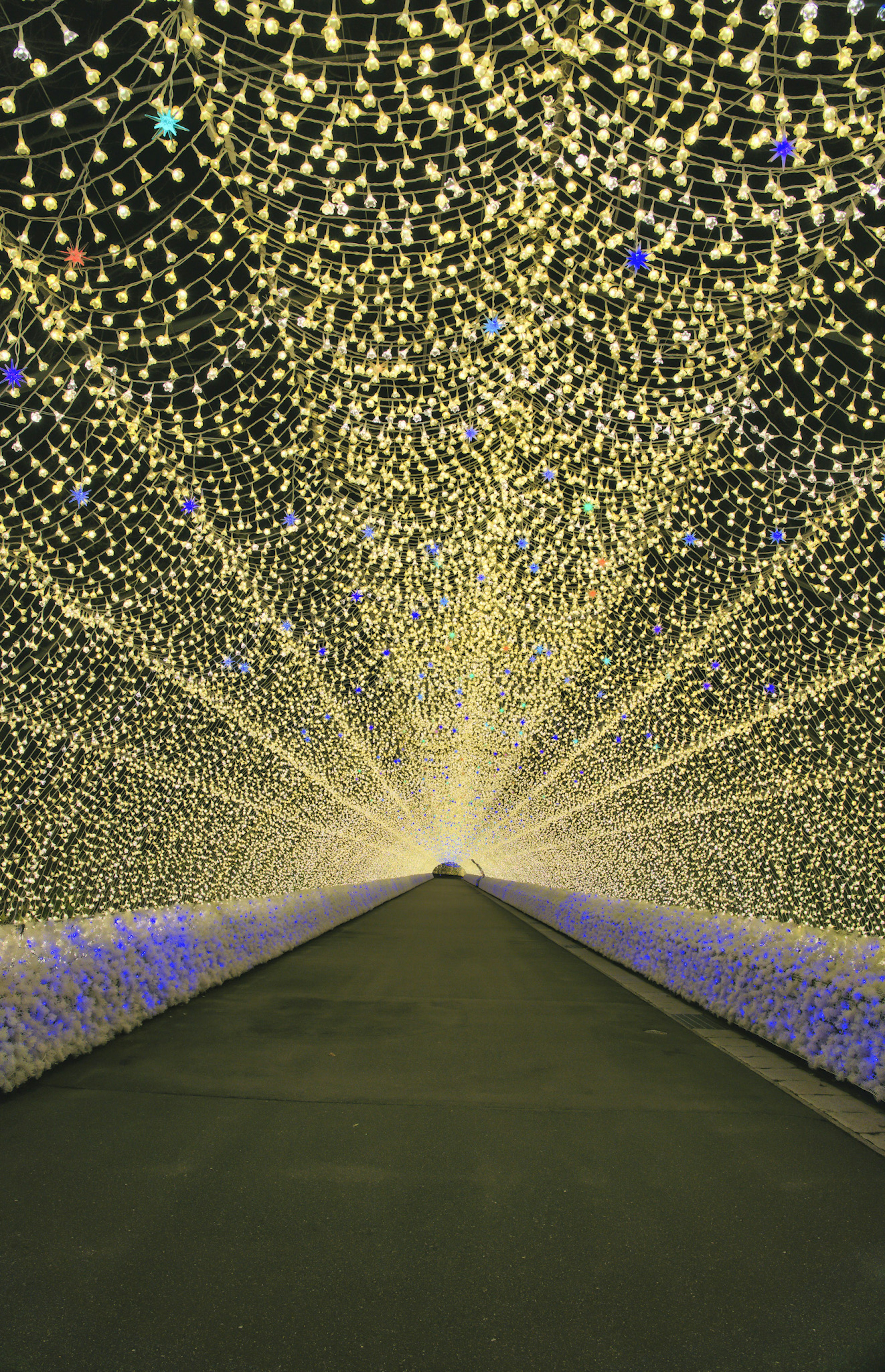 Illuminated tunnel with a pathway leading into bright lights