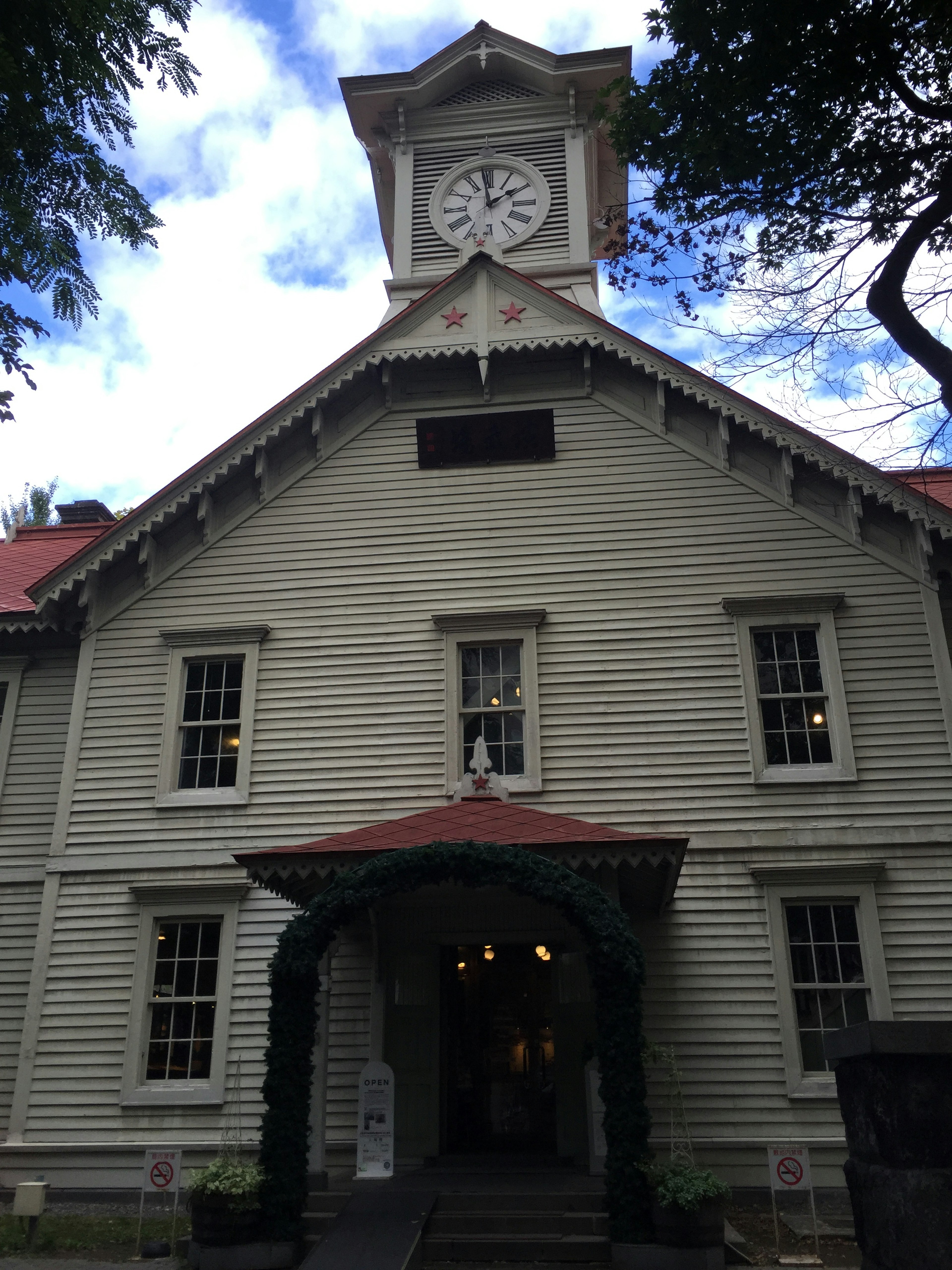 Exterior of a wooden building with a prominent clock tower