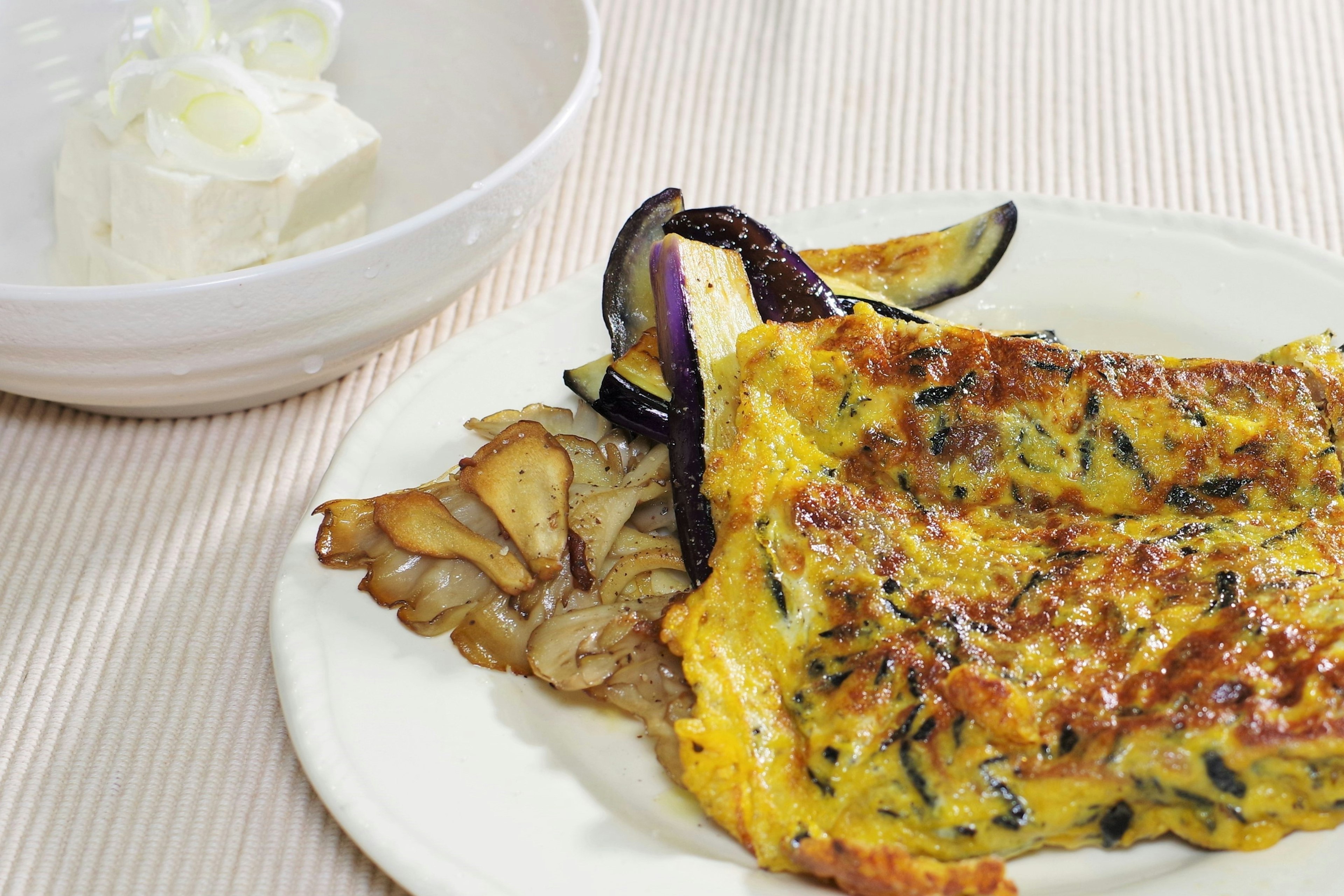 Assiette d'omelette avec légumes grillés et crème à côté