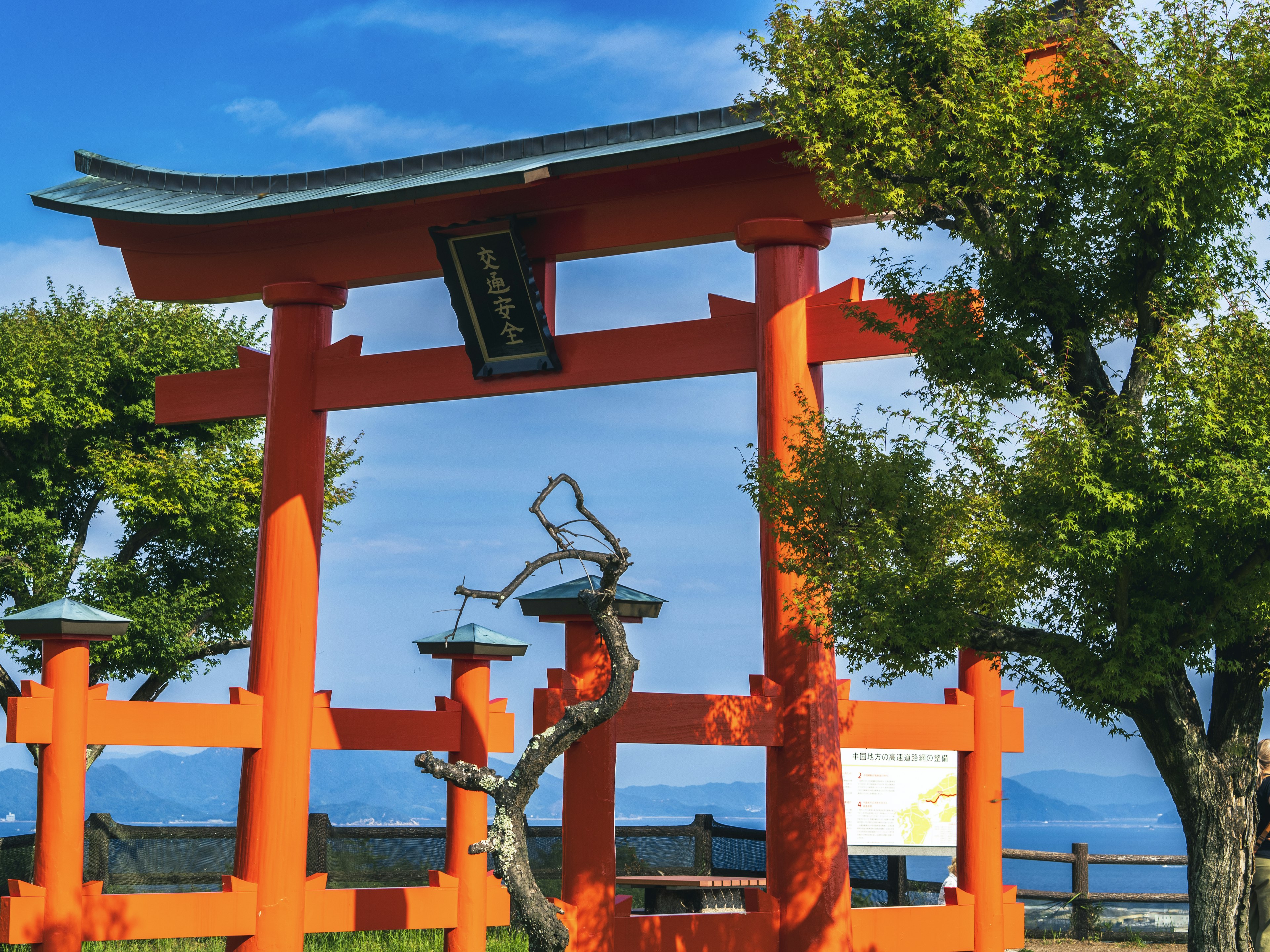 Orange torii gate against a blue sky