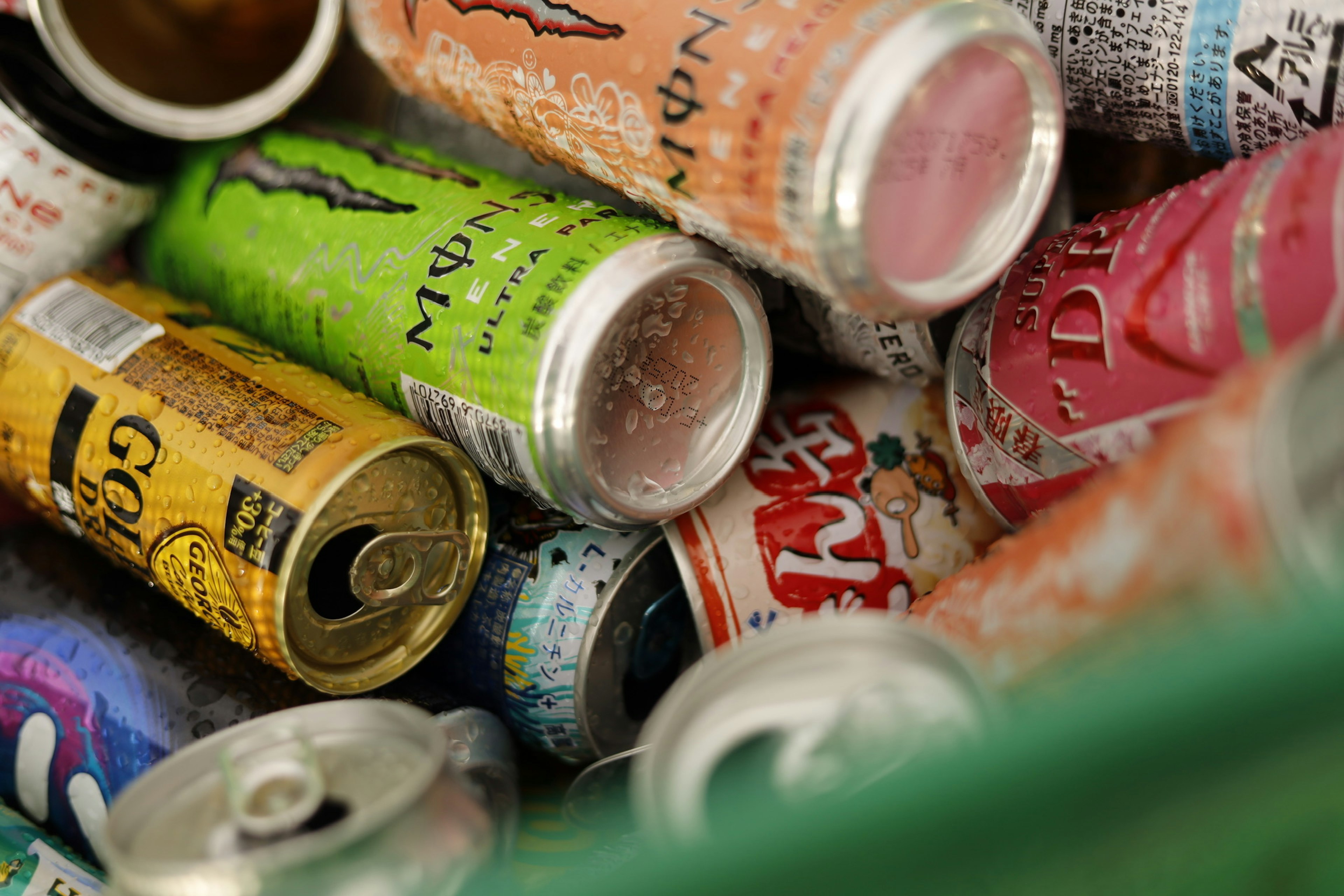 A collection of colorful energy drink cans piled together