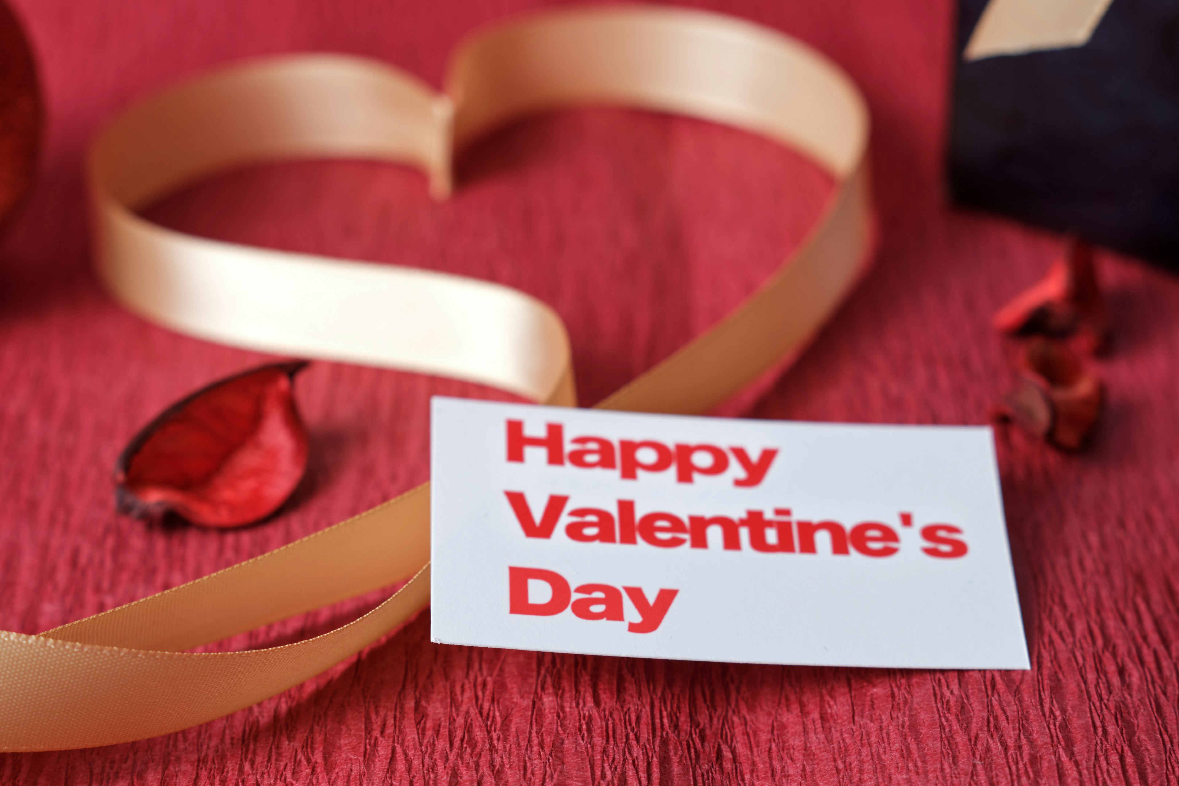 Valentine's Day message card with heart-shaped ribbon