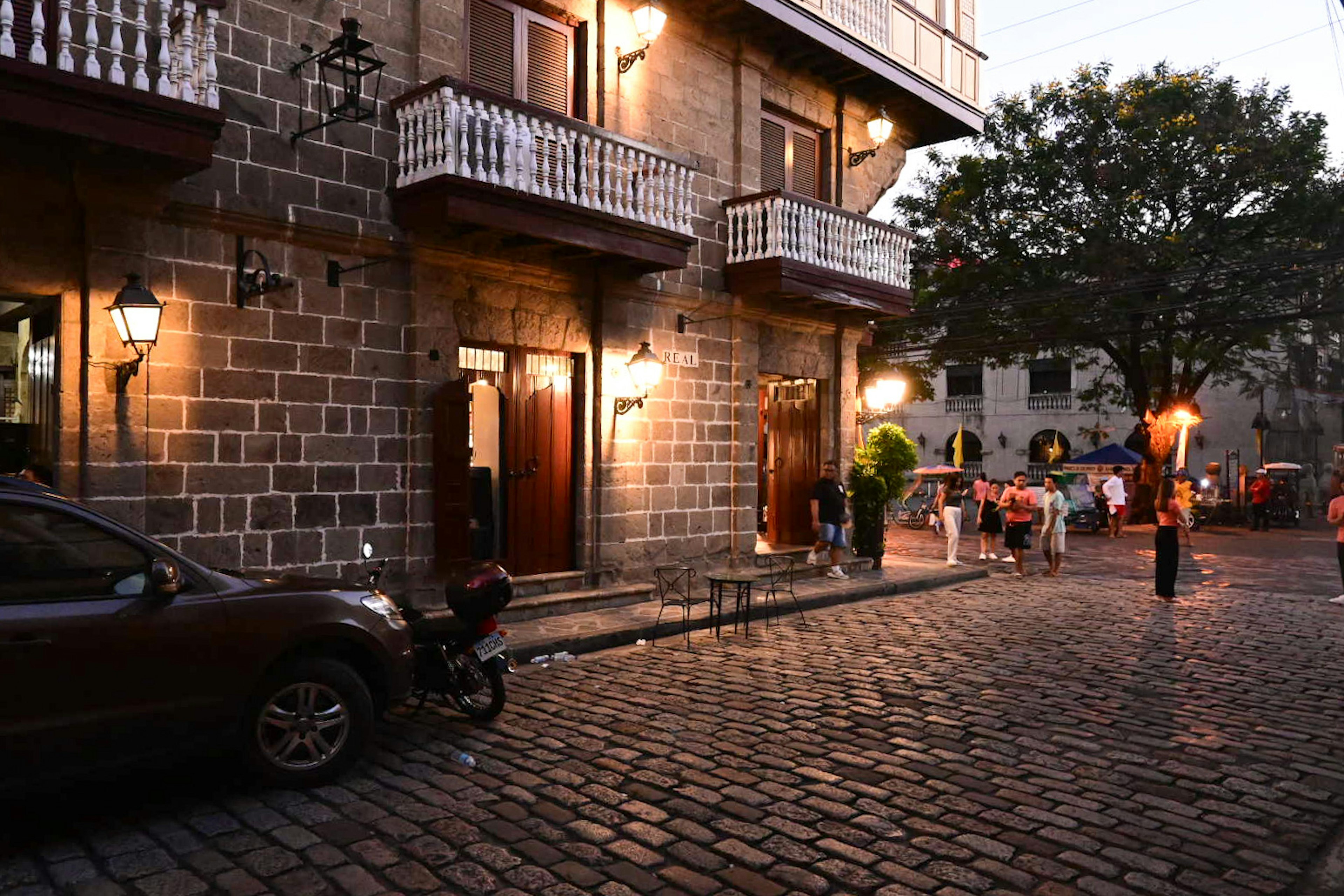 Night scene featuring stone buildings and cobblestone street