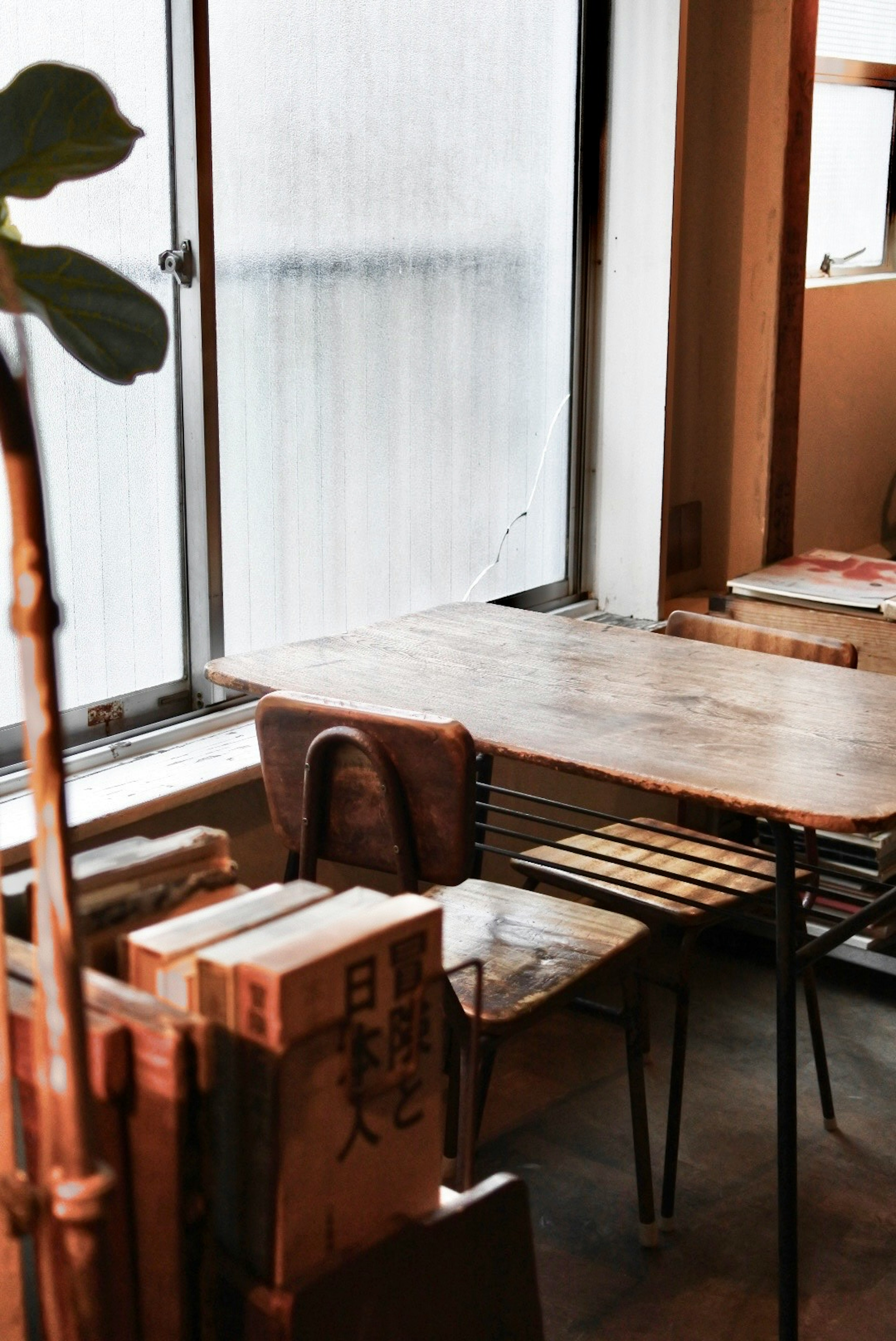 Cozy cafe interior with wooden table and chairs natural light filtering through window