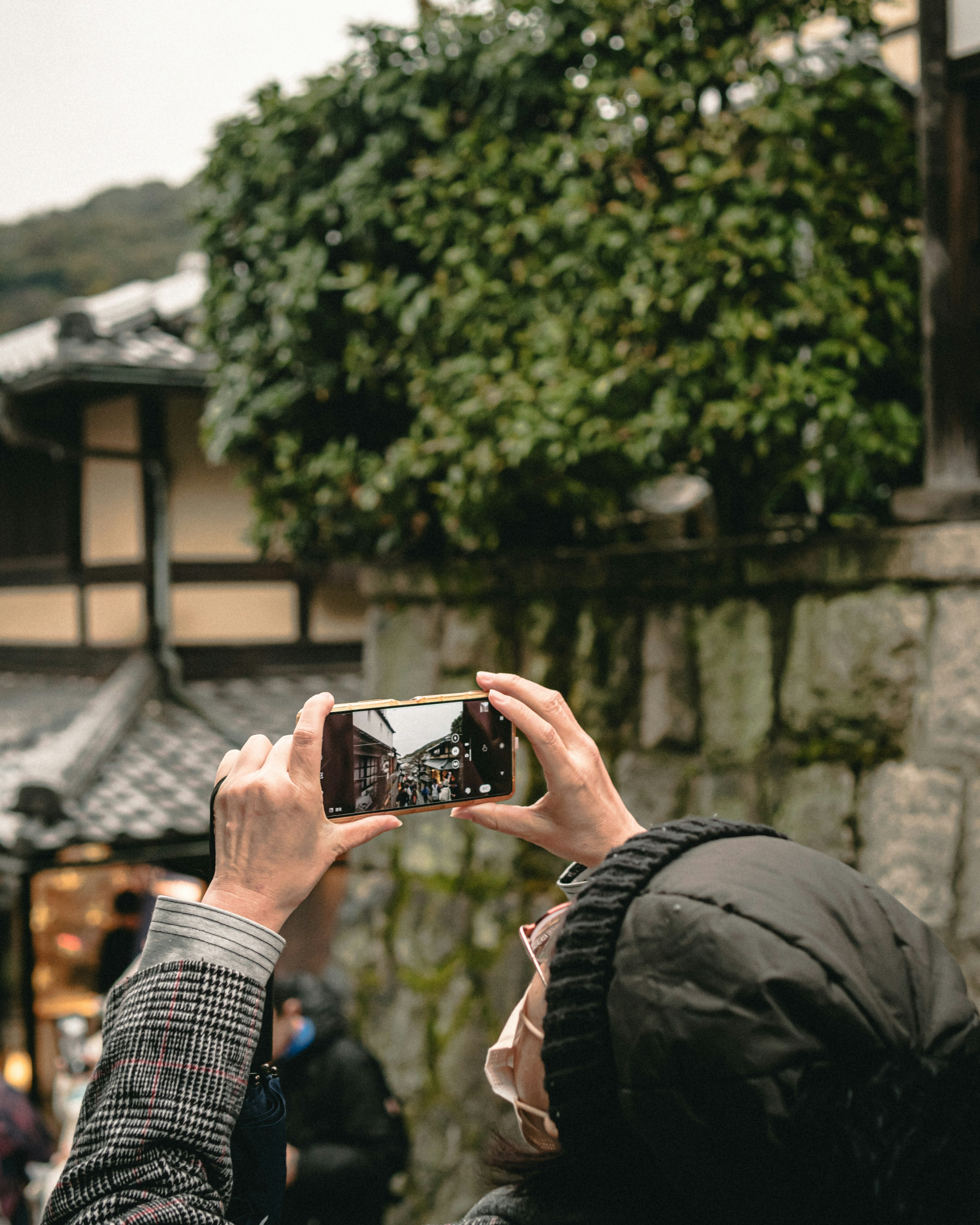 A person taking a photo with a smartphone in a historic setting