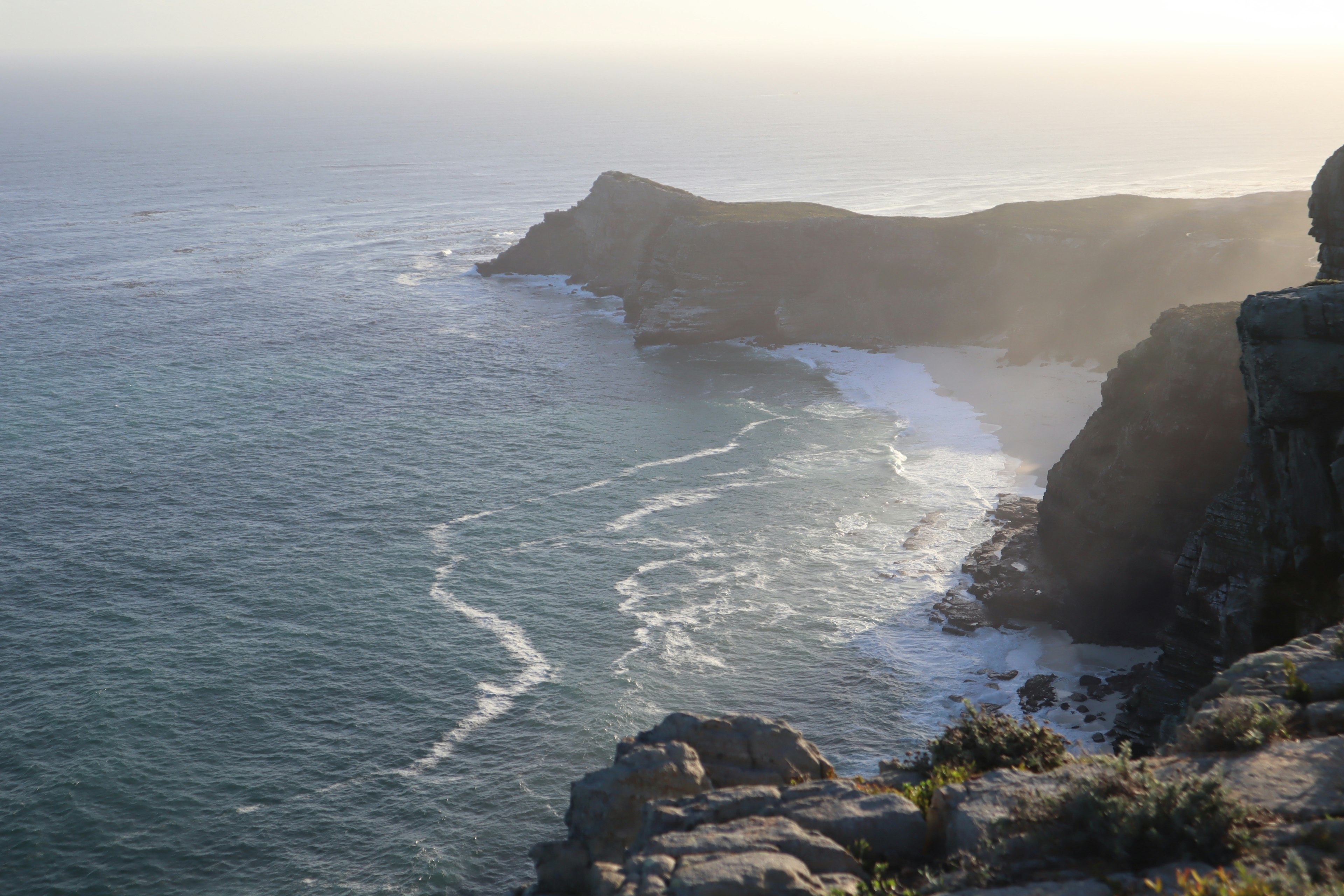 Coastal landscape with waves crashing against cliffs