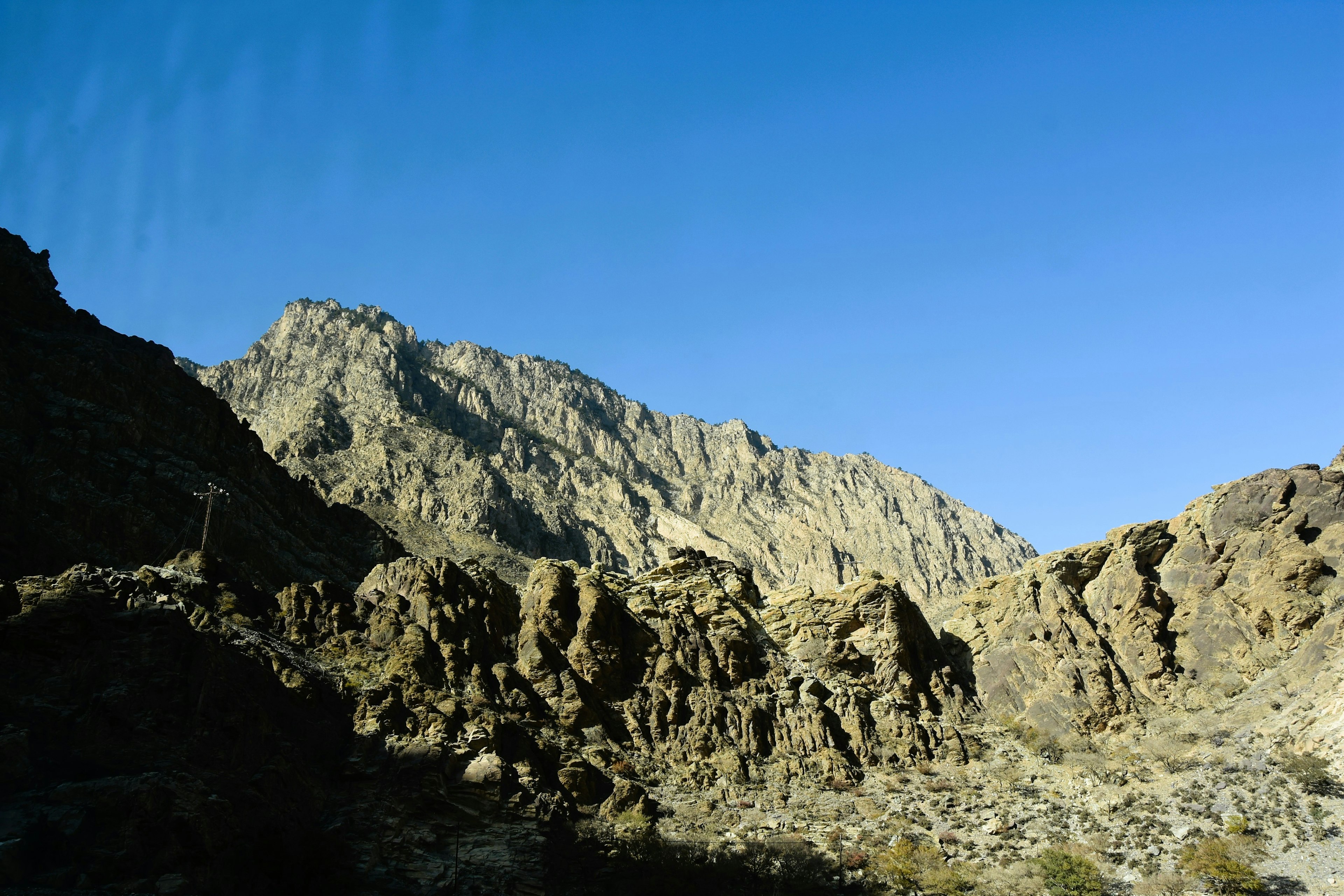 Mountain landscape with rocky terrain under a clear blue sky