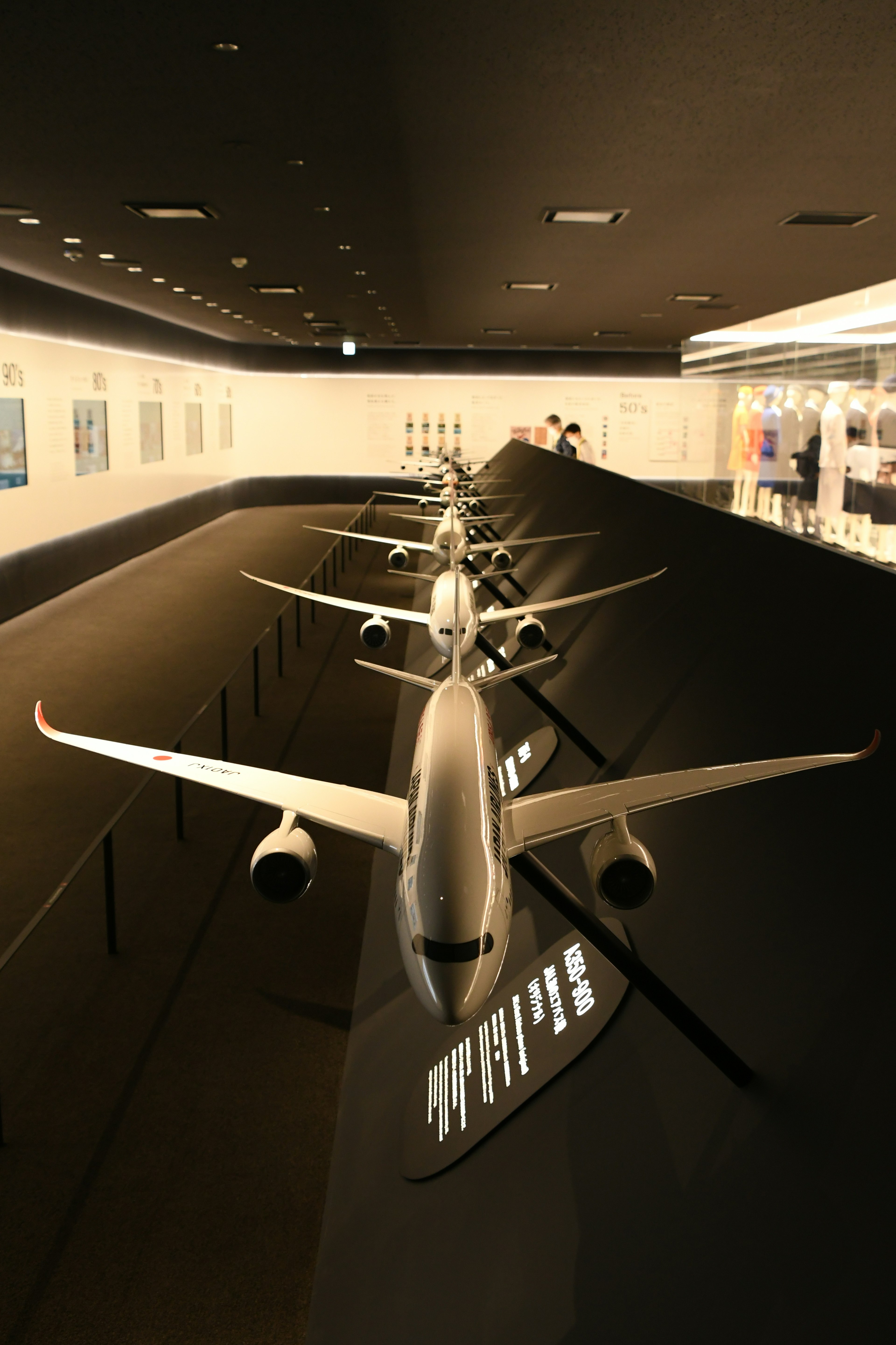 Several airplane models displayed in an airport exhibition