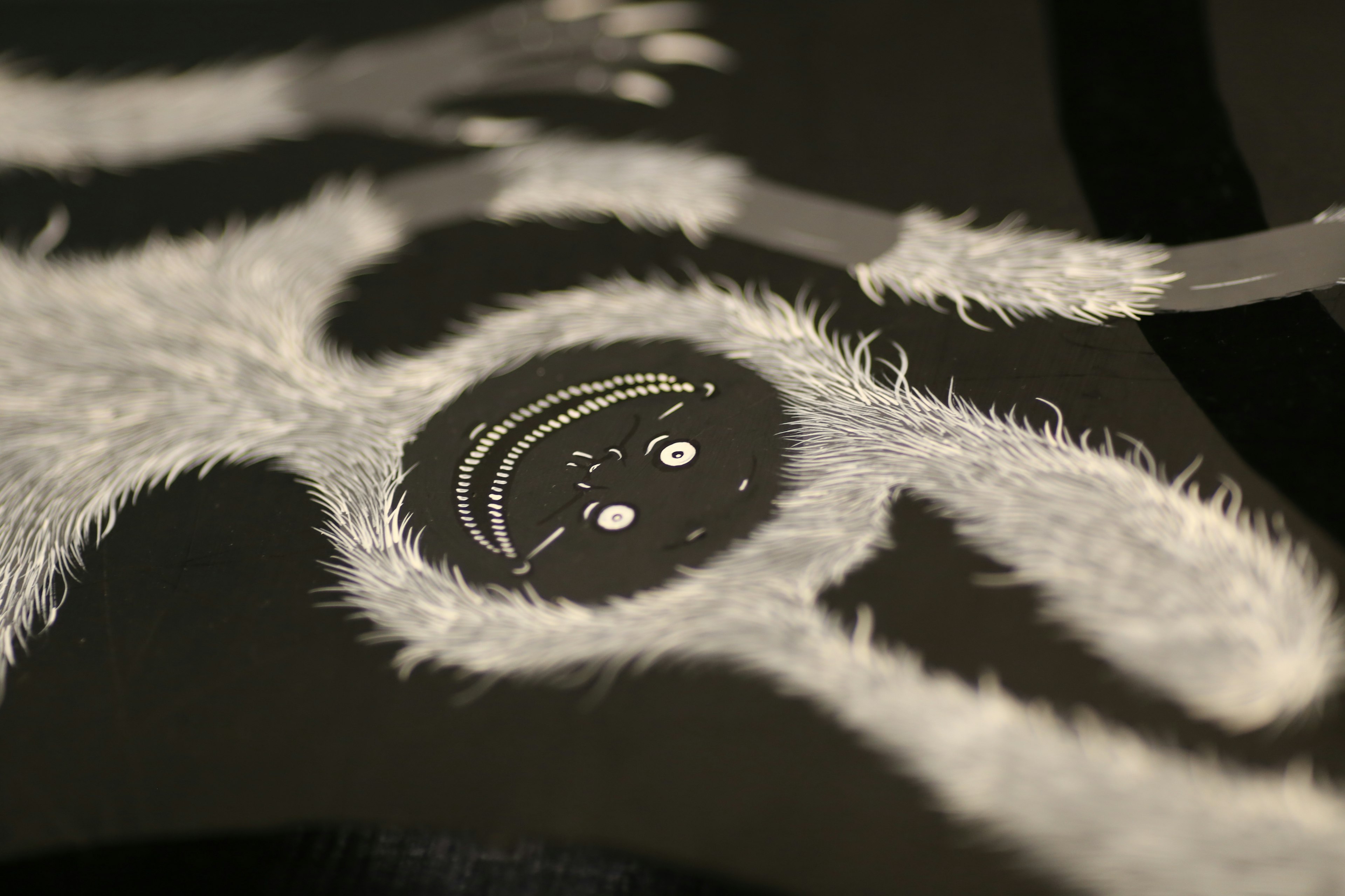 A furry white character face depicted on a black background