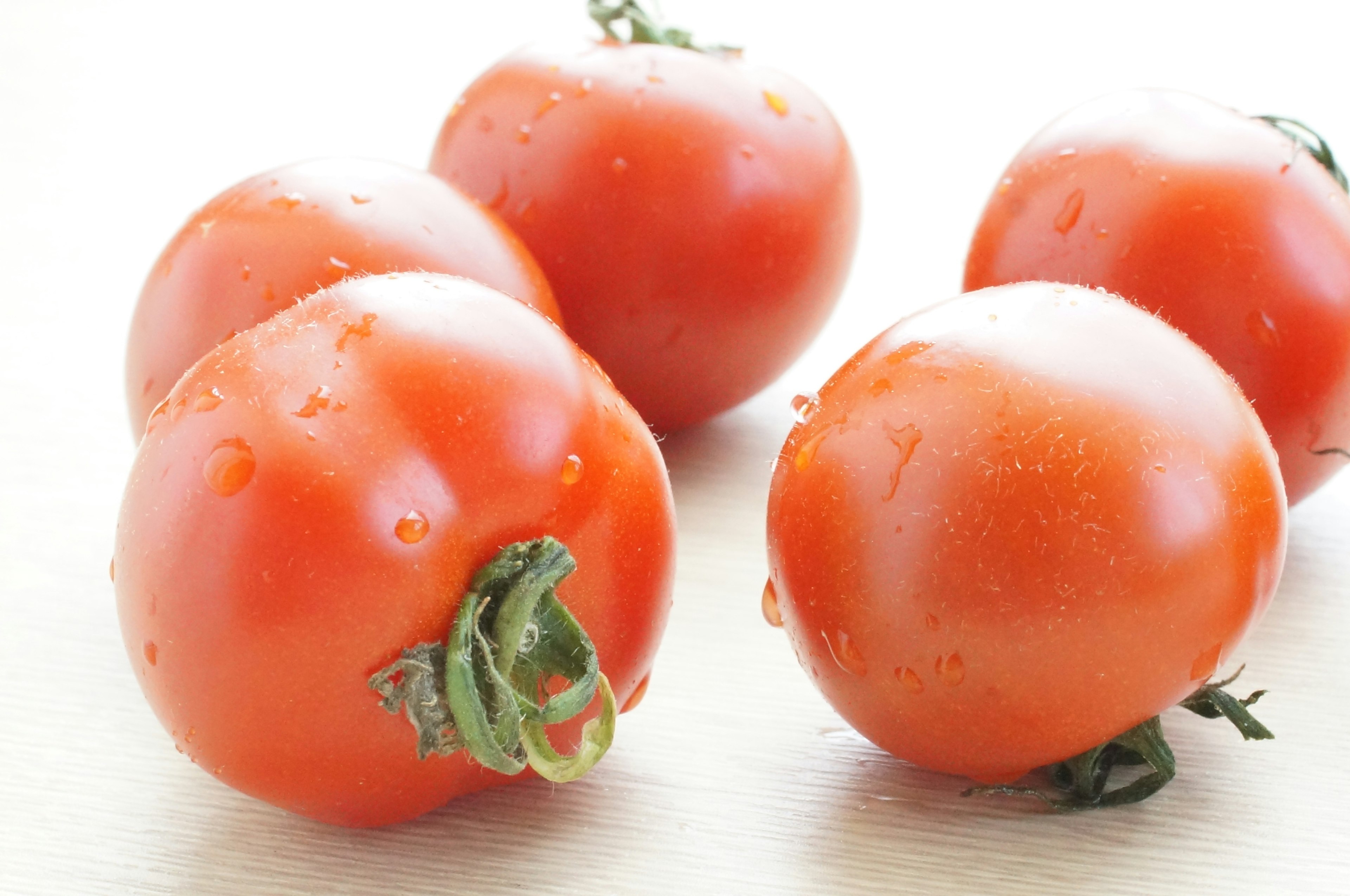 Fresh red tomatoes arranged on a table