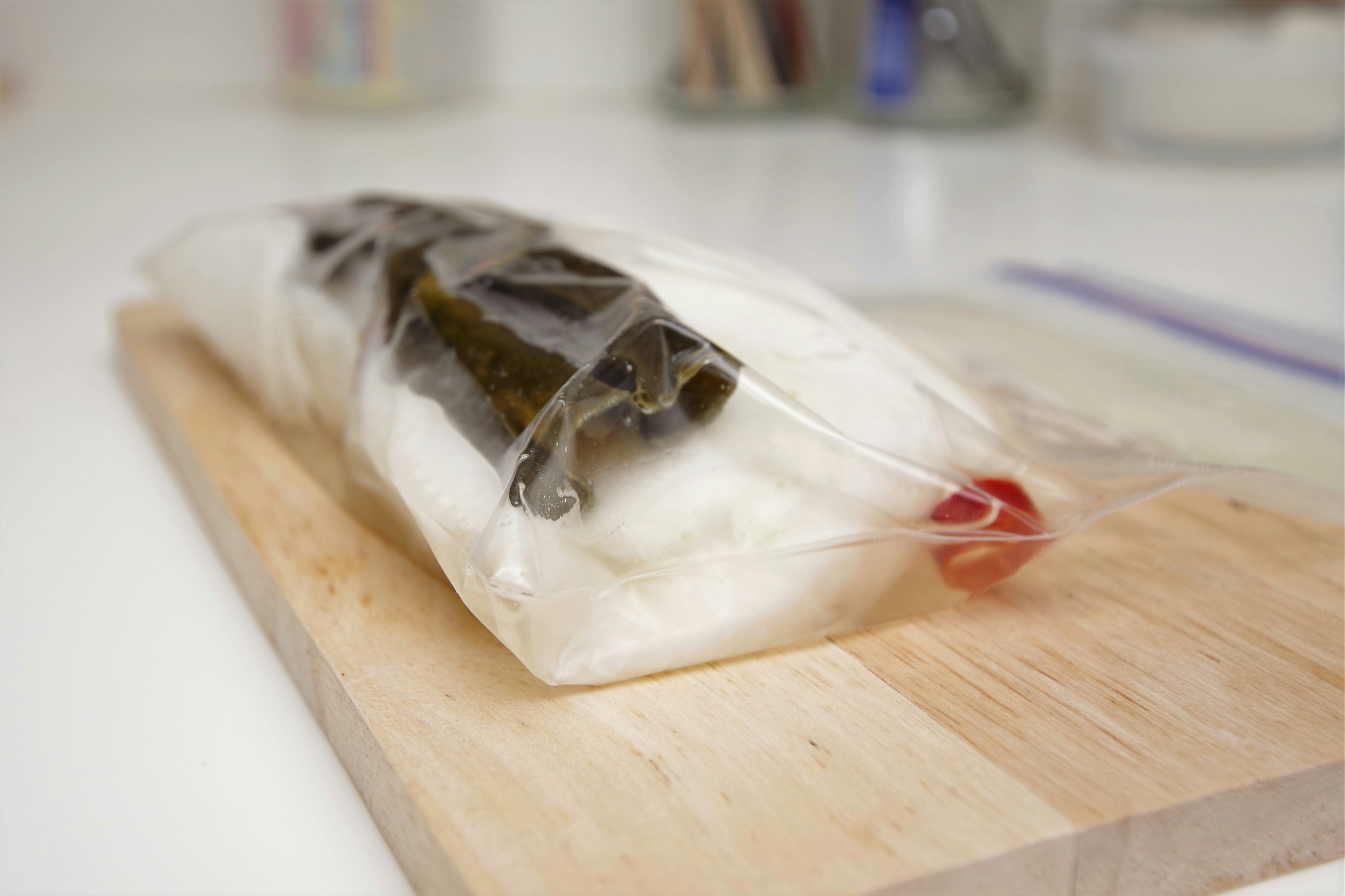 A roll of rice and seaweed in a clear plastic bag