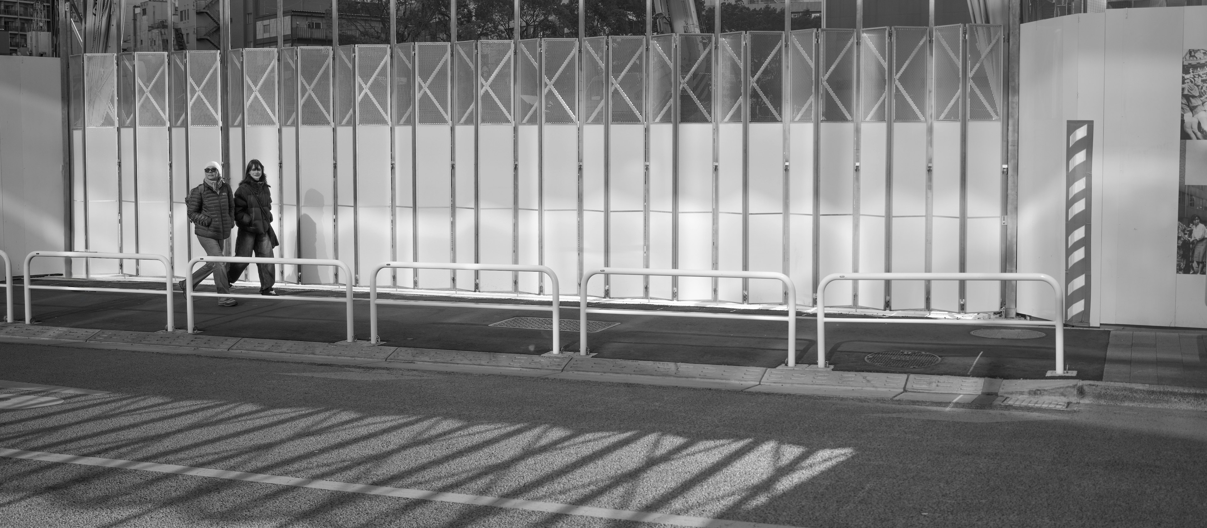 Dos personas caminando lado a lado en un entorno en blanco y negro