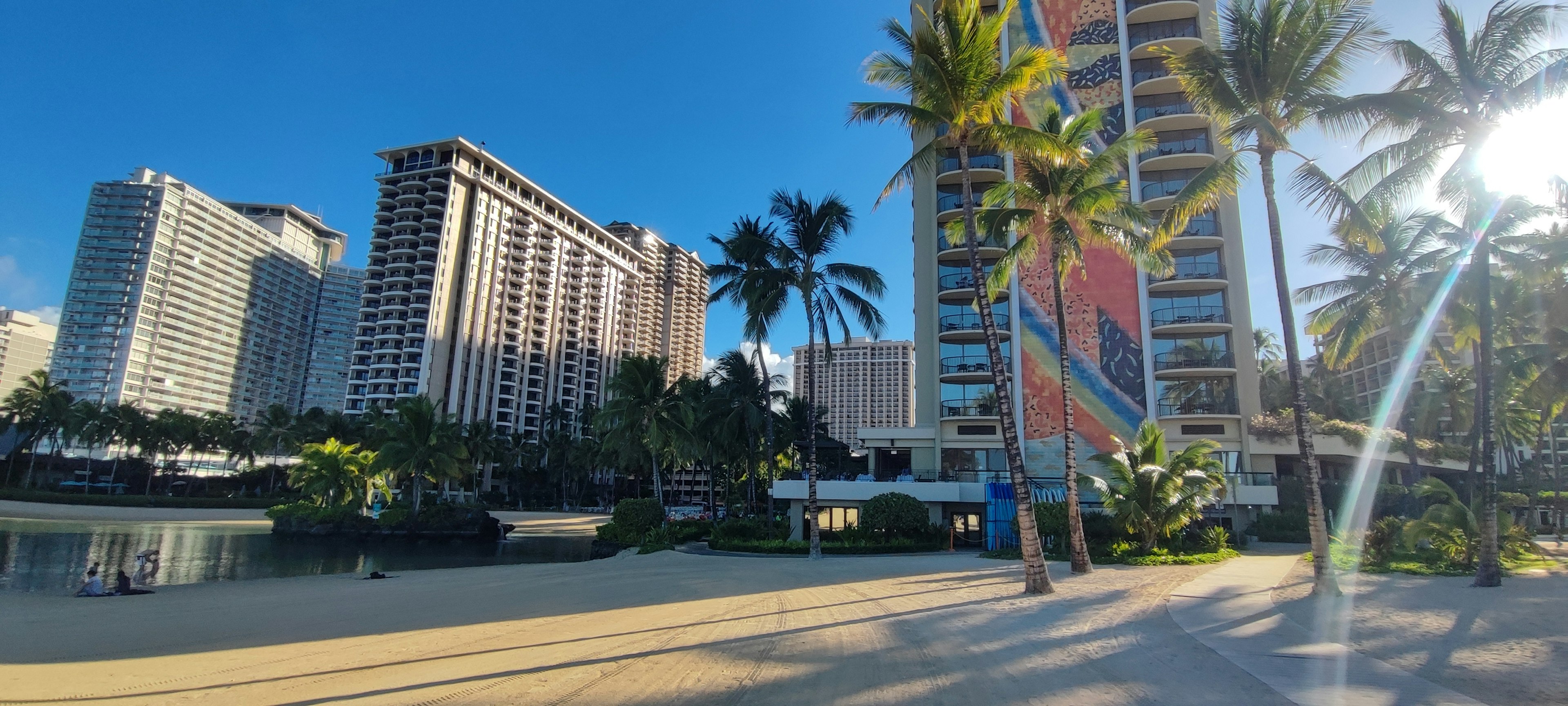 Beach view with high-rise buildings under a clear blue sky