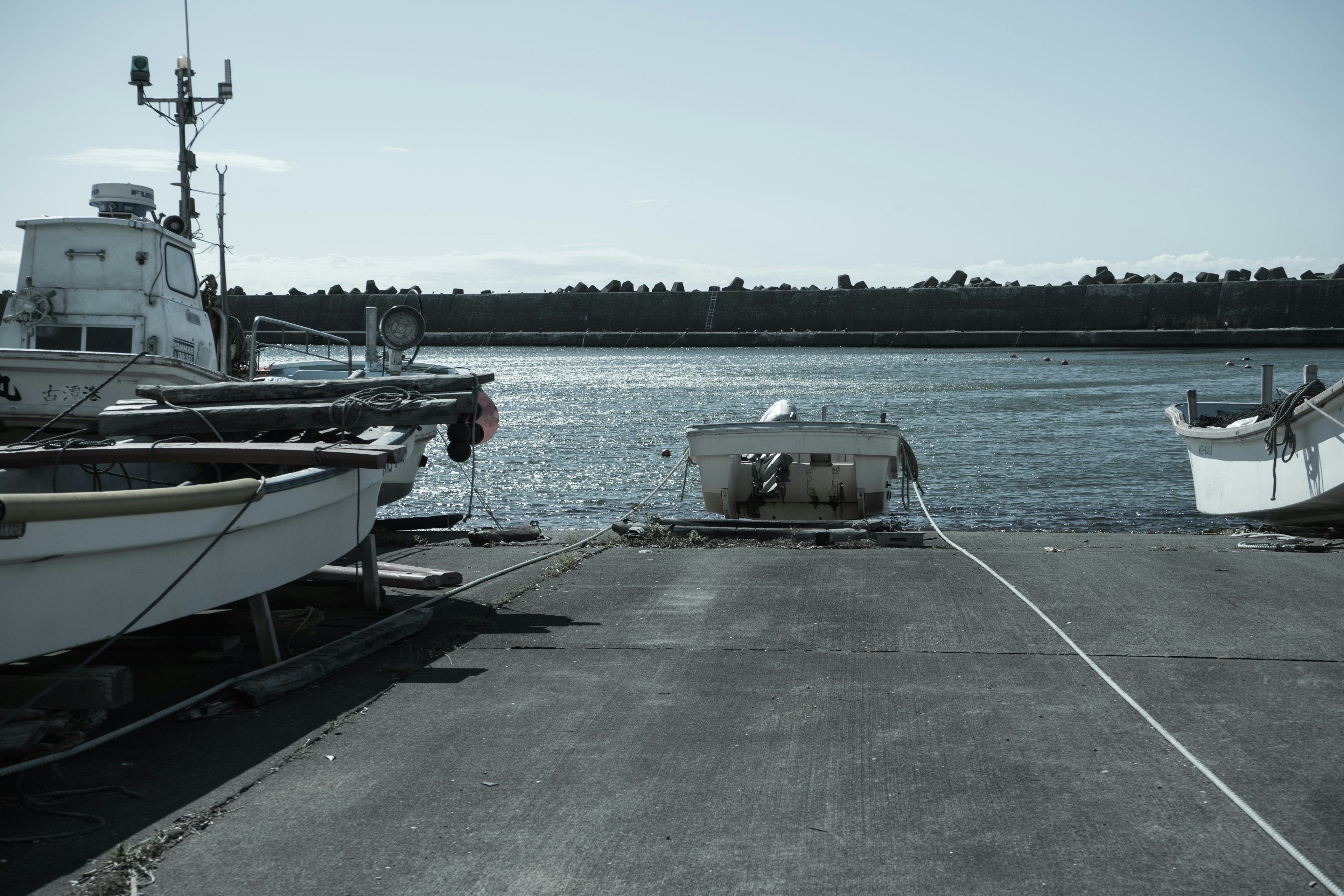 Fishing boats docked at a harbor with calm water