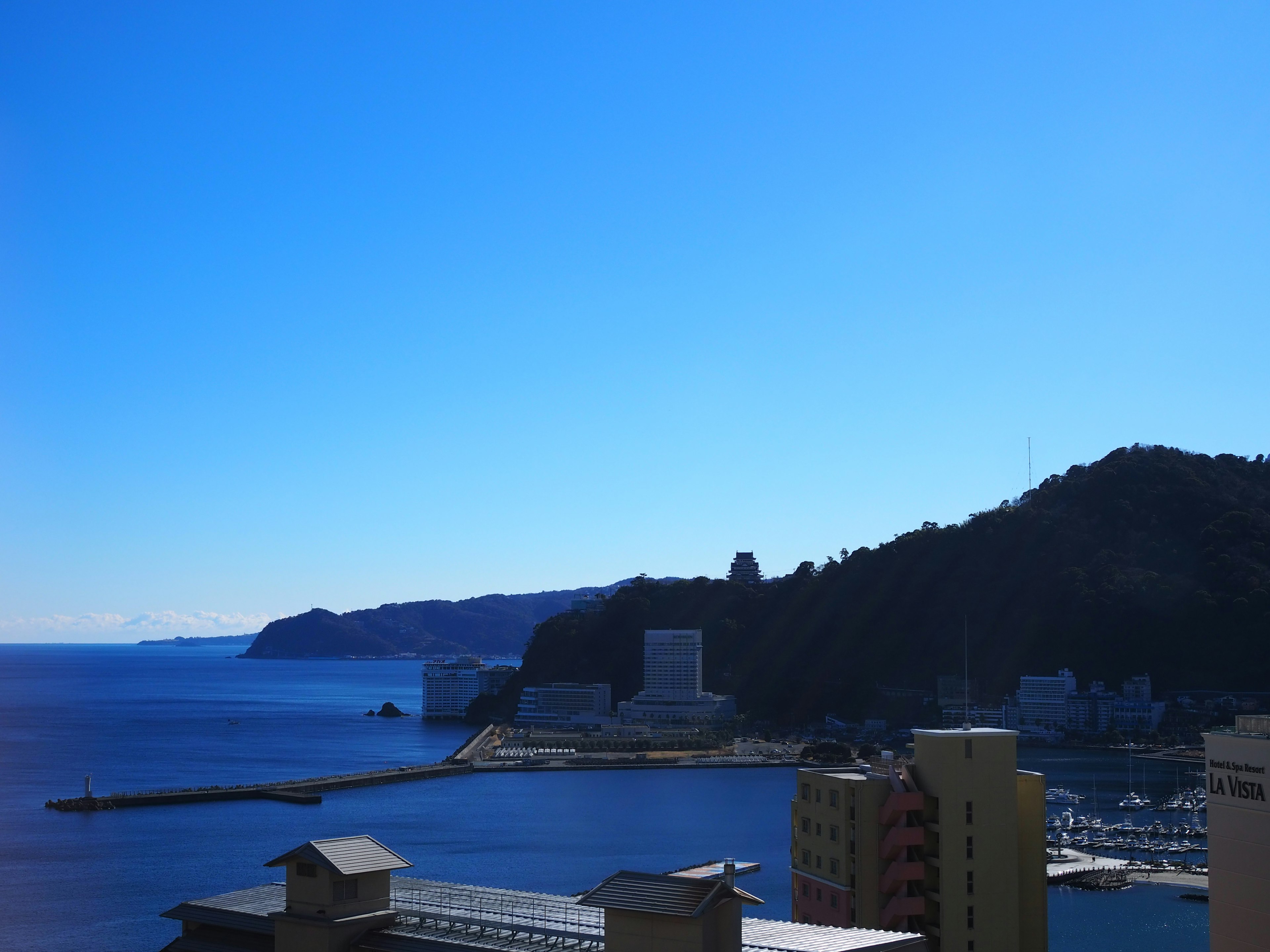 Scenic view of a coastal town with clear blue sky and ocean