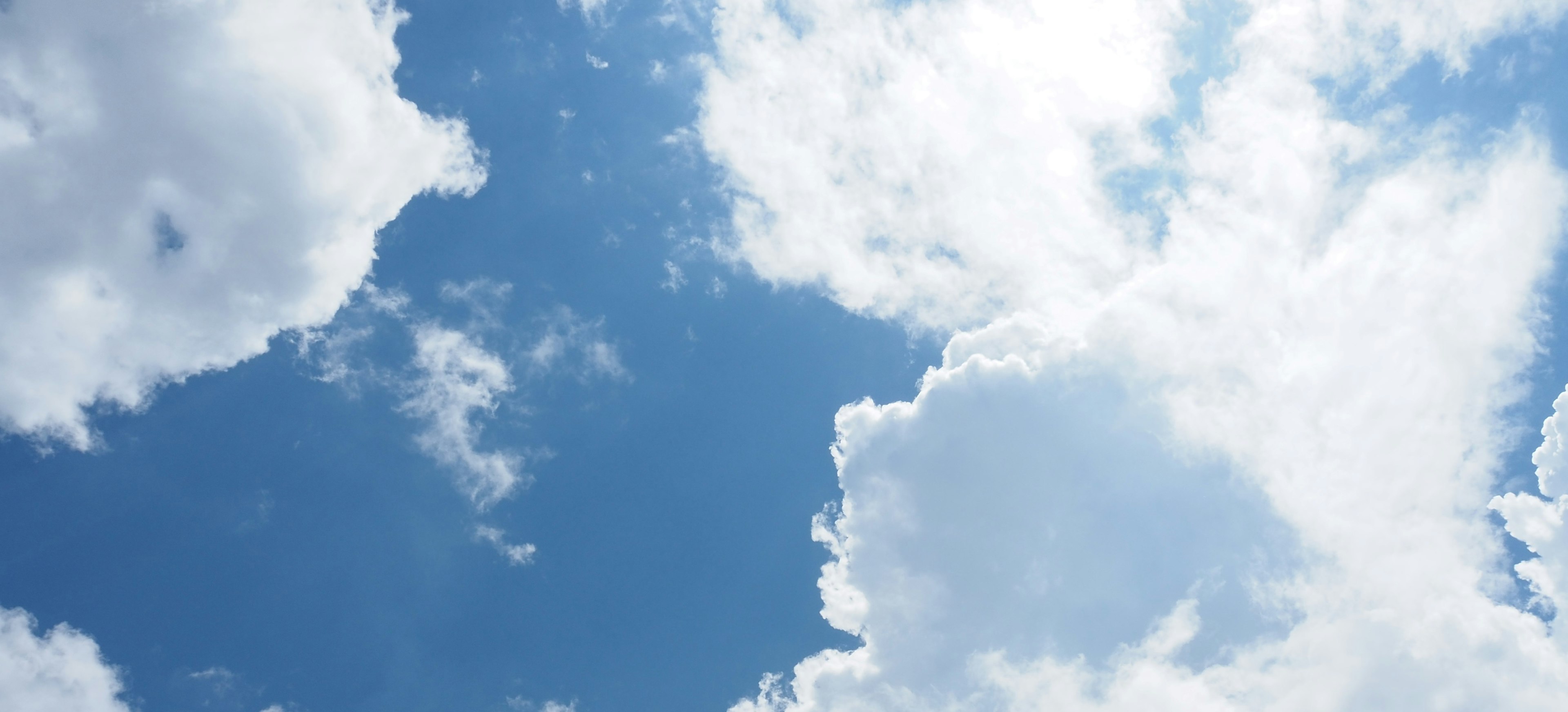 A bright blue sky filled with fluffy white clouds