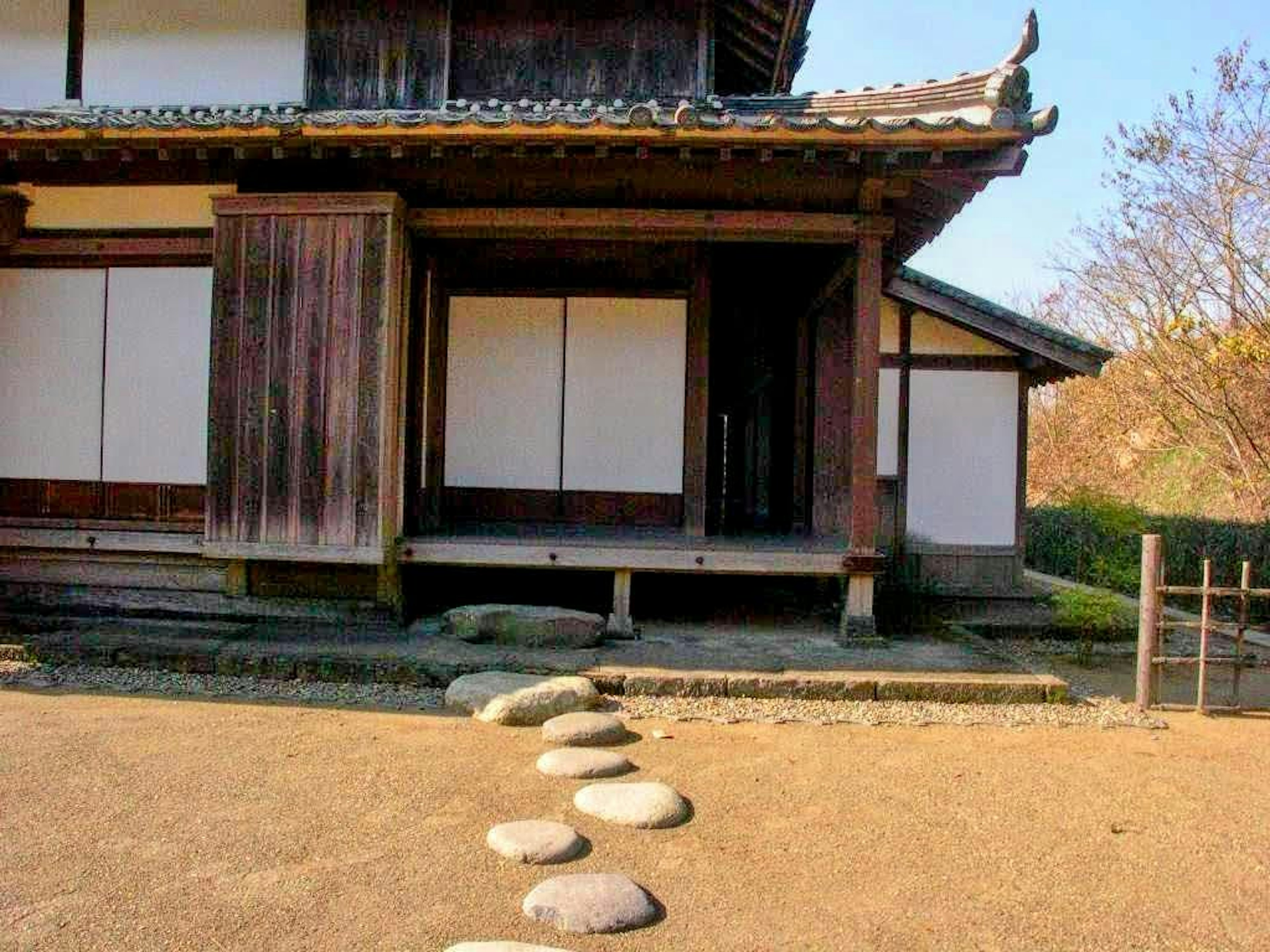 Traditional Japanese house exterior with stone pathway