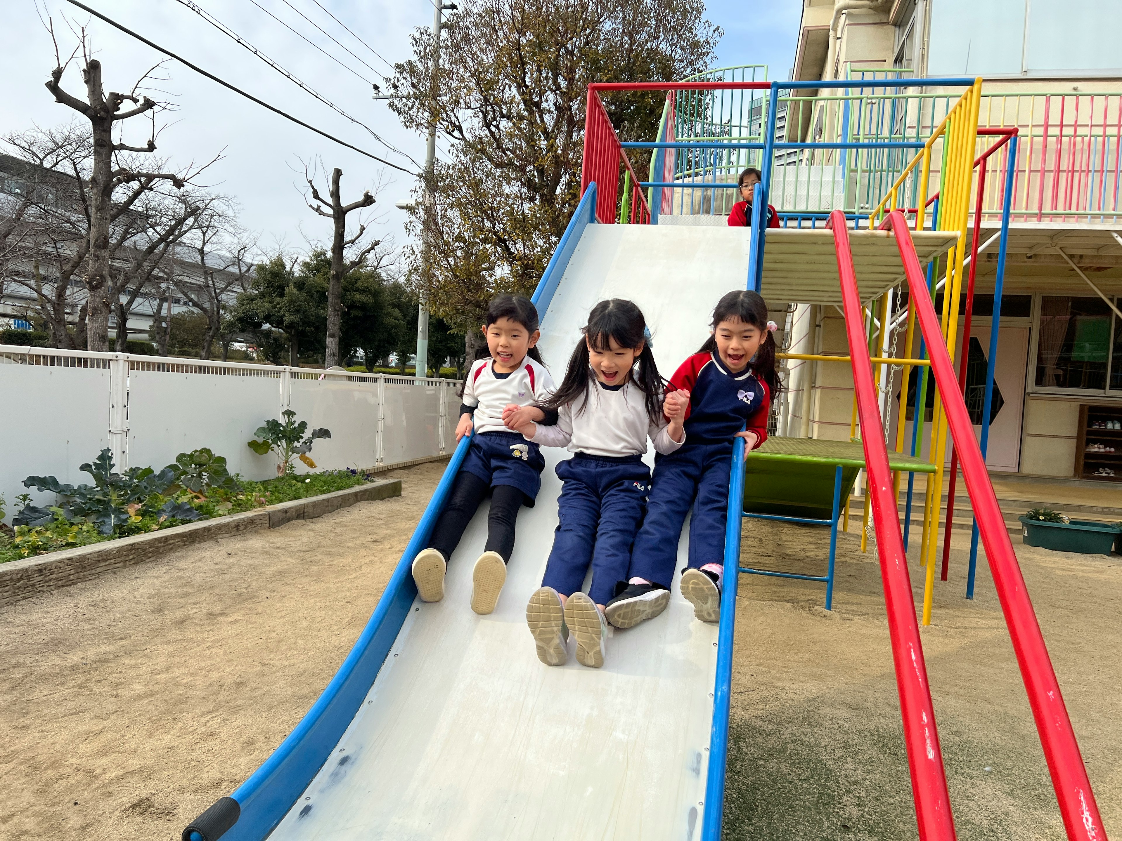 Niños jugando en un tobogán colorido en un parque