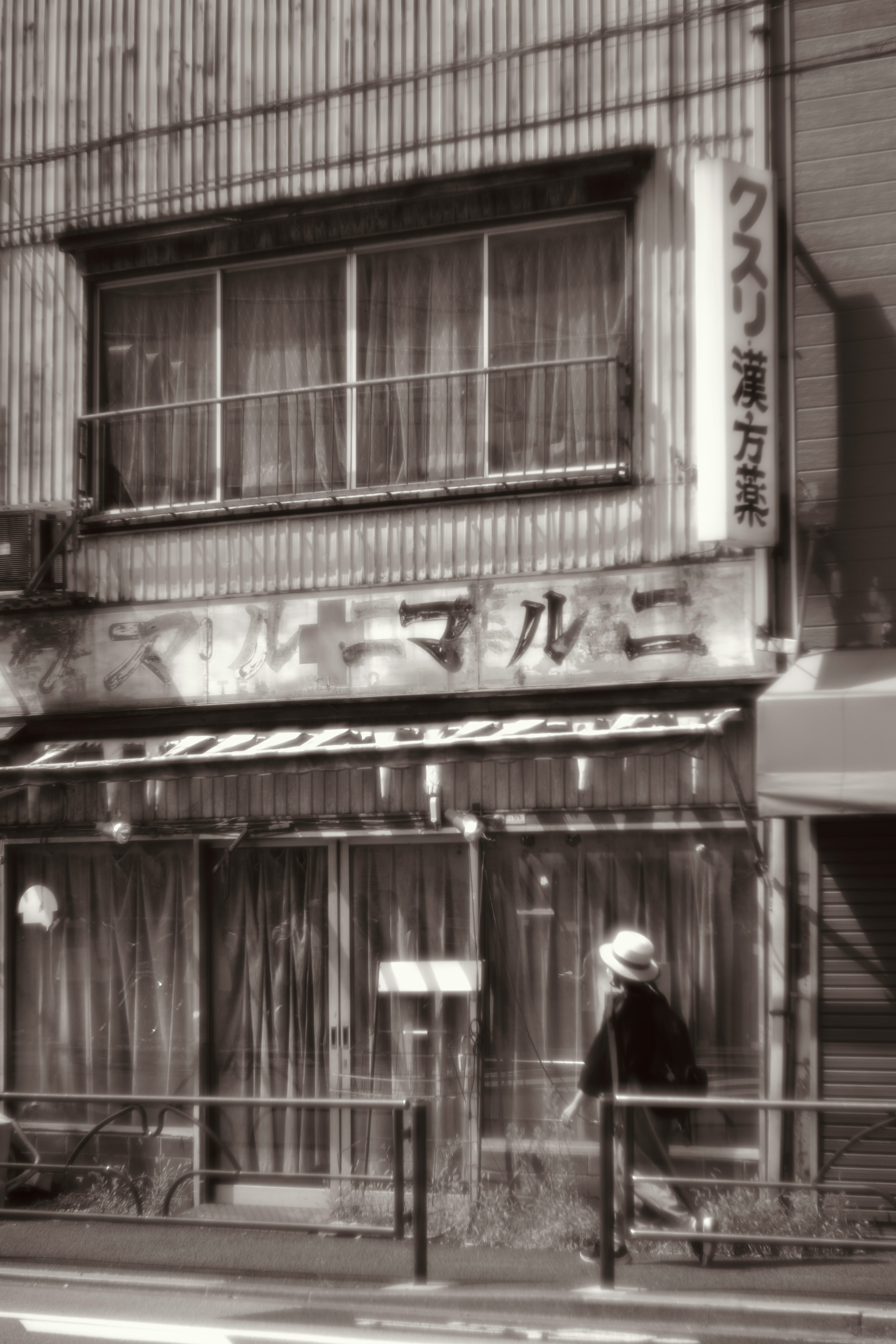 Façade d'un vieux magasin avec une personne marchant