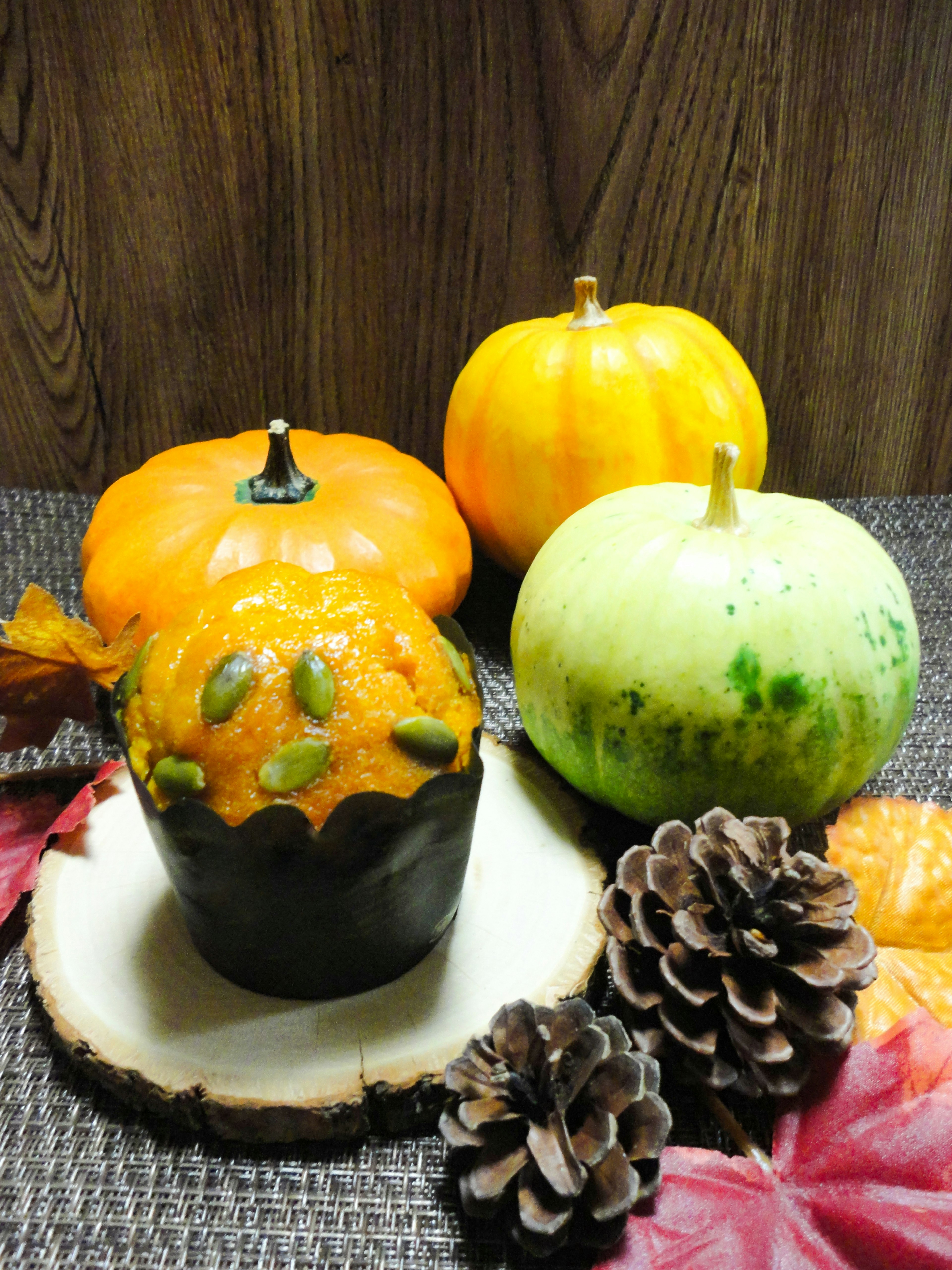 Colorful pumpkins and pine cones arranged in a fall decoration