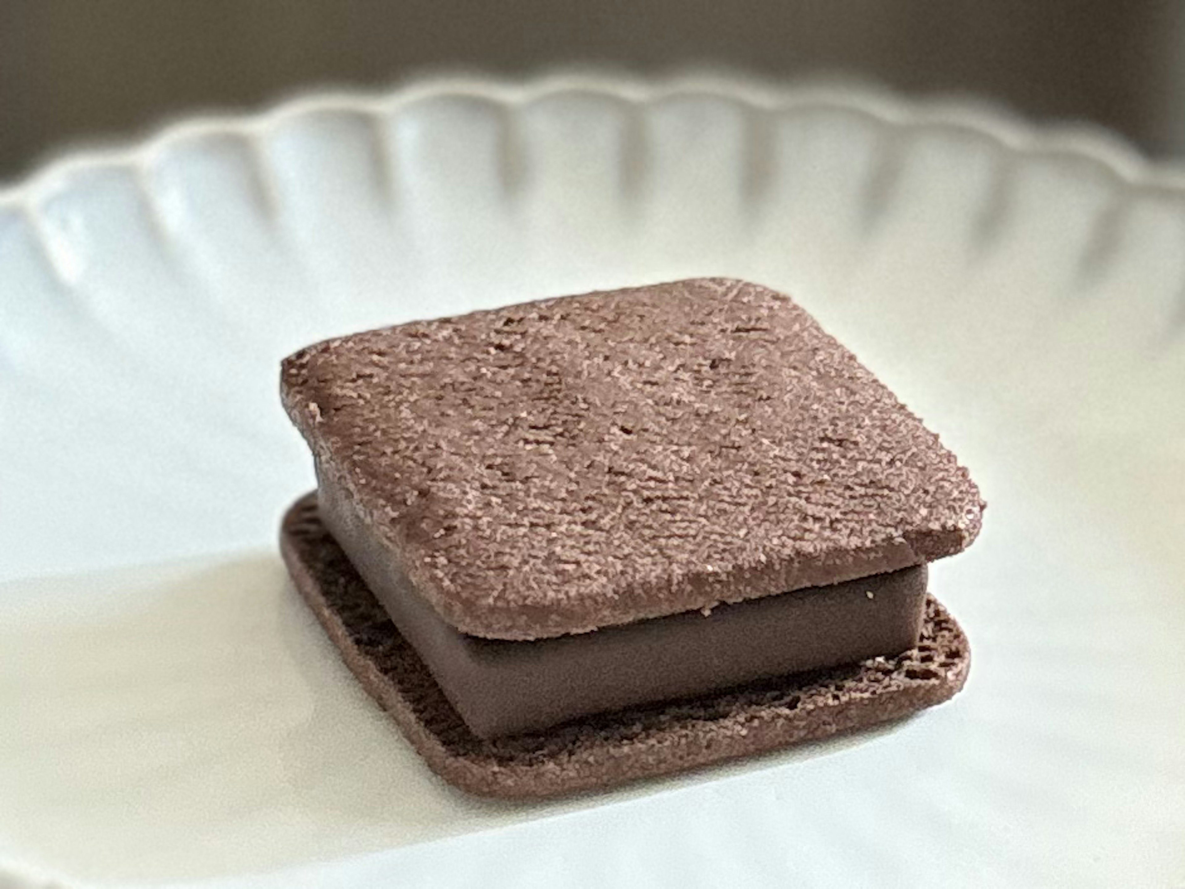 Chocolate sandwich cookie placed on a white plate