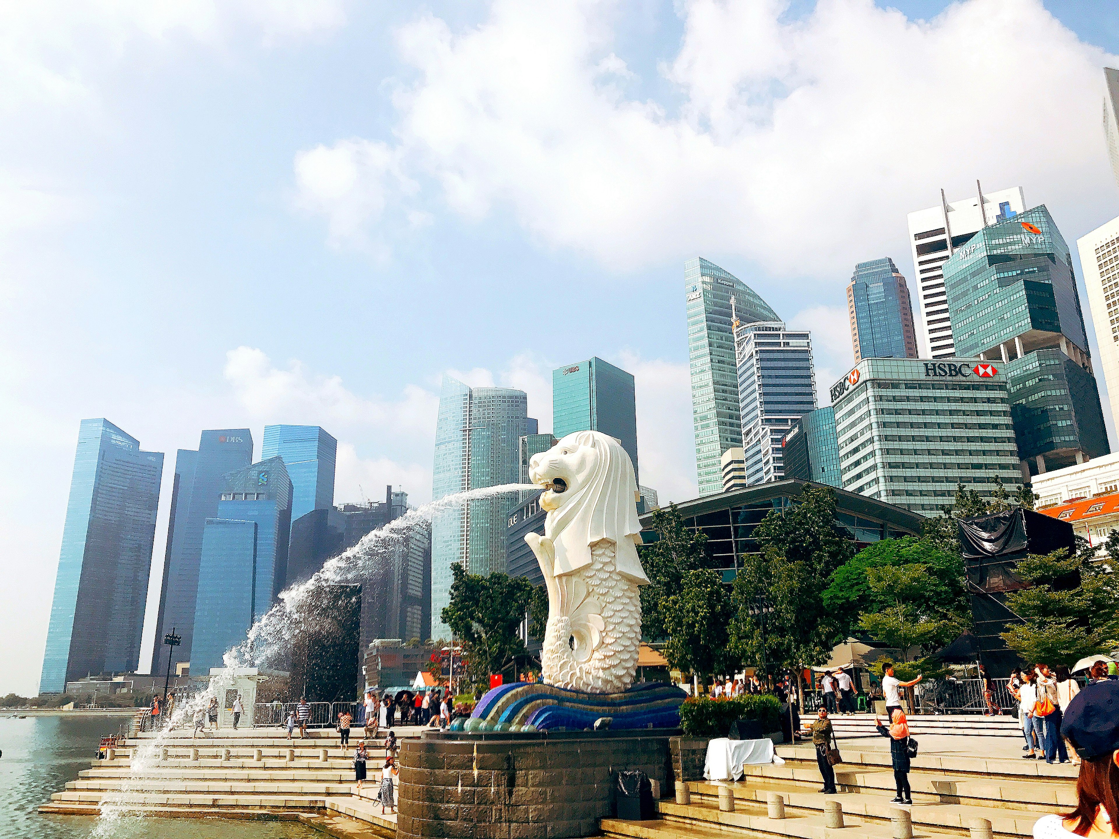 Singapore's Merlion statue with a backdrop of skyscrapers