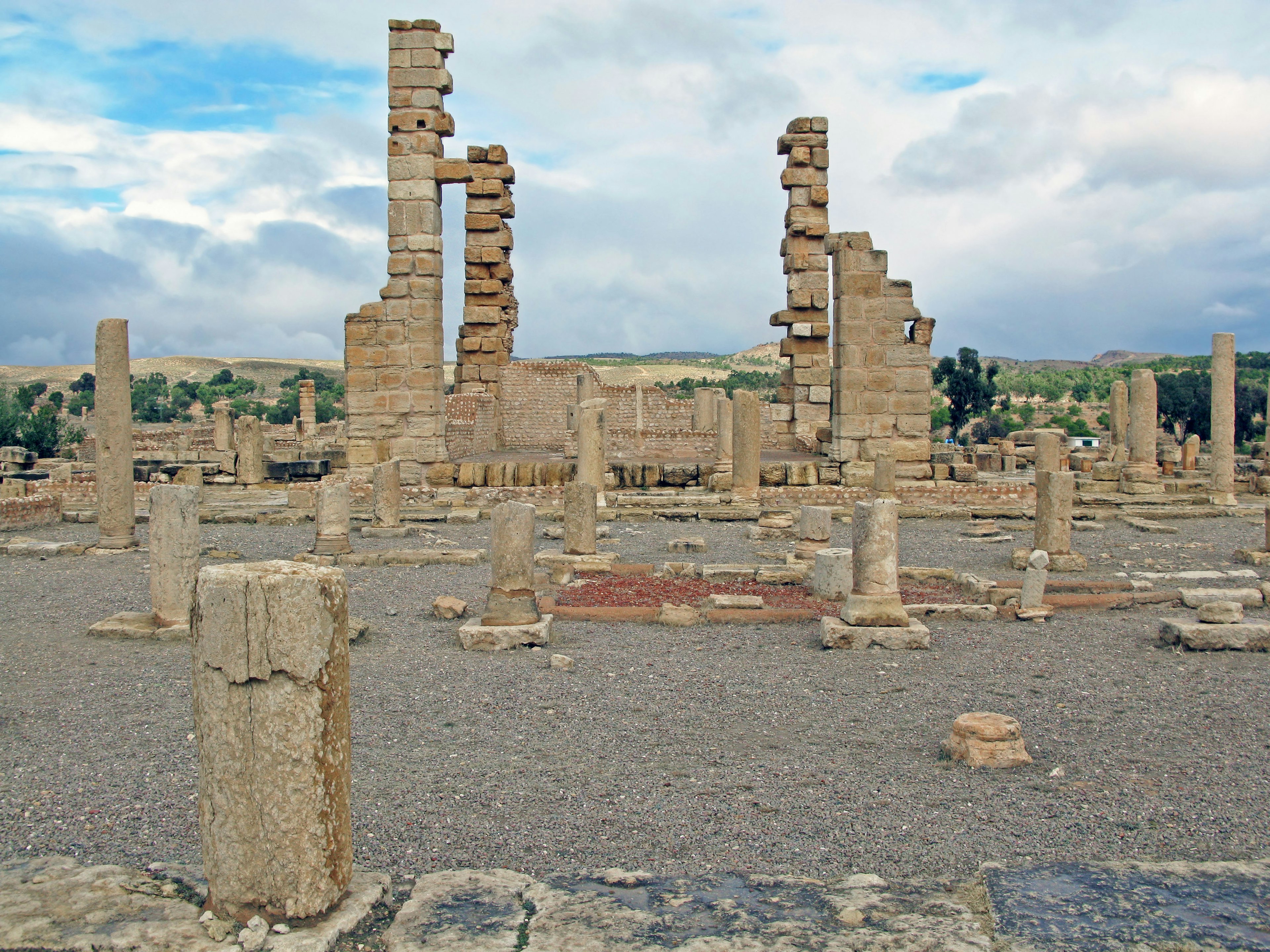 Landscape featuring ancient ruins with columns and walls