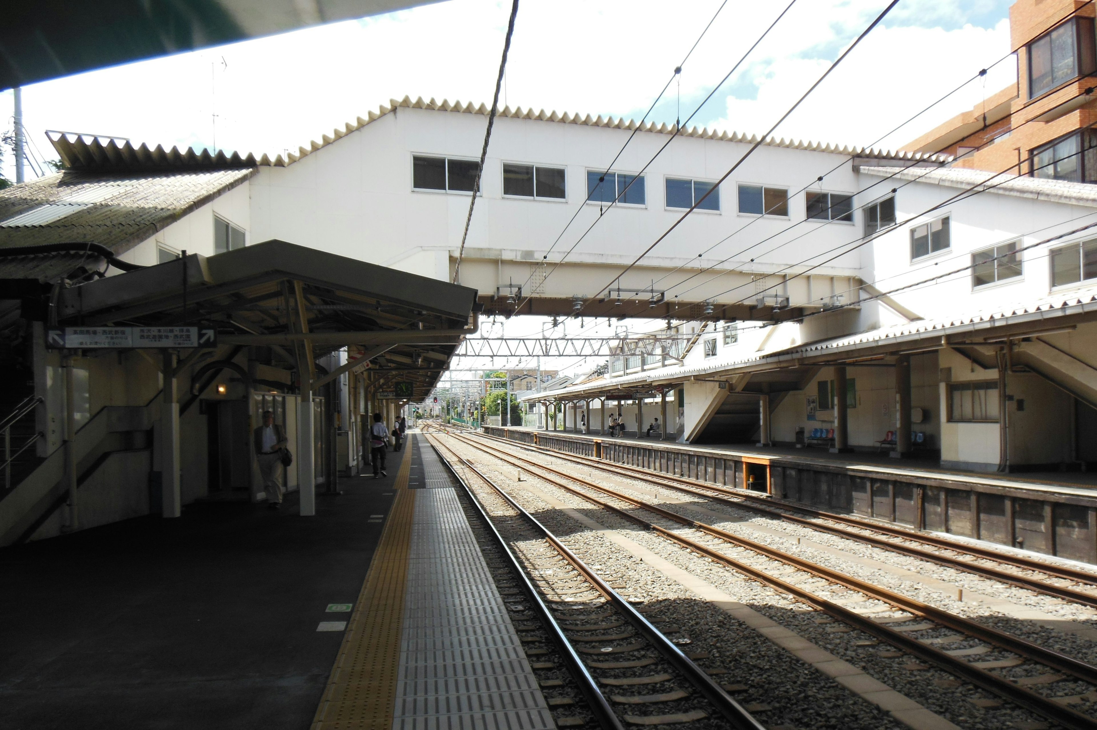 View of a quiet train station platform and tracks