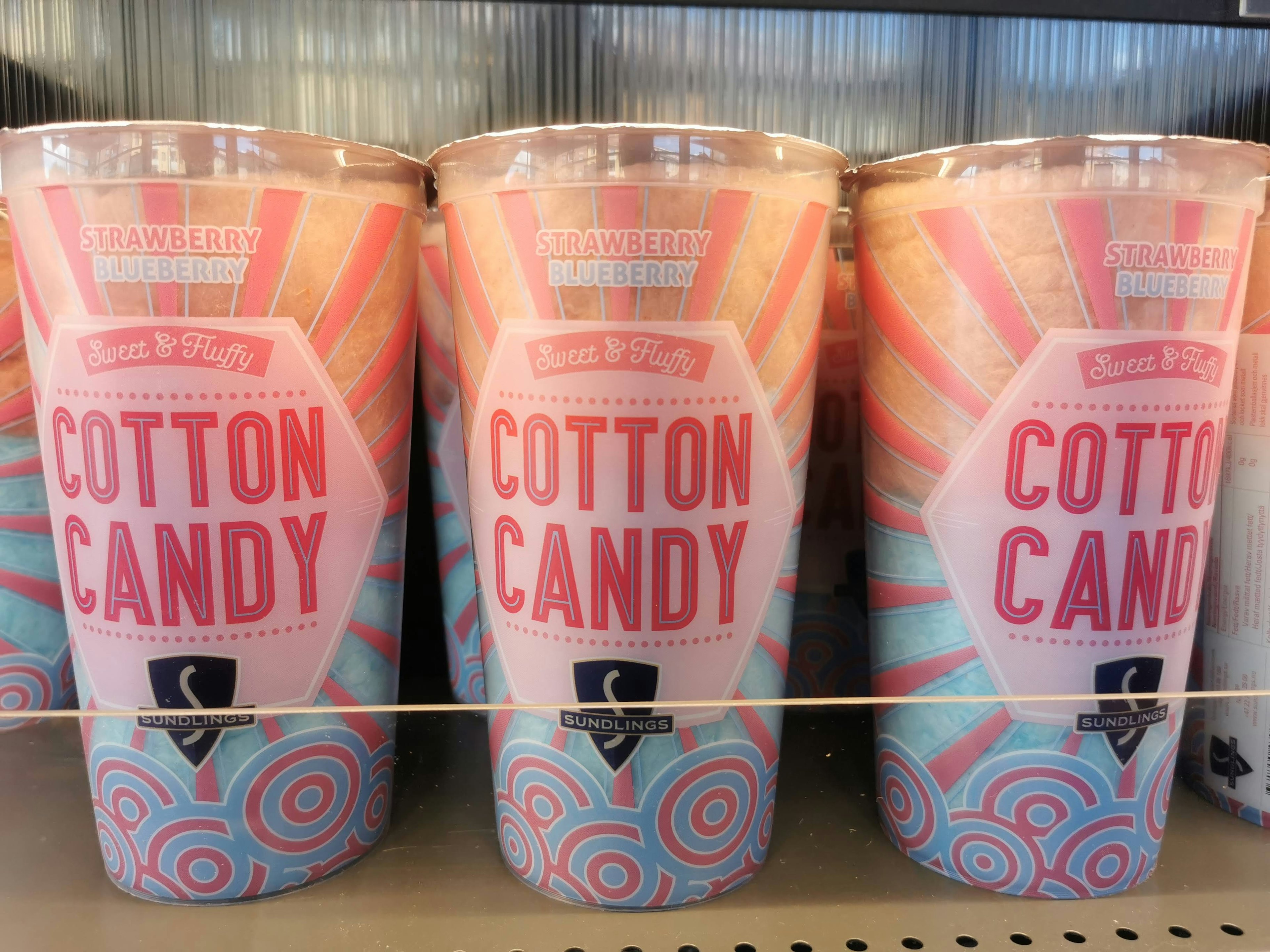 Colorful cotton candy cups displayed on a shelf