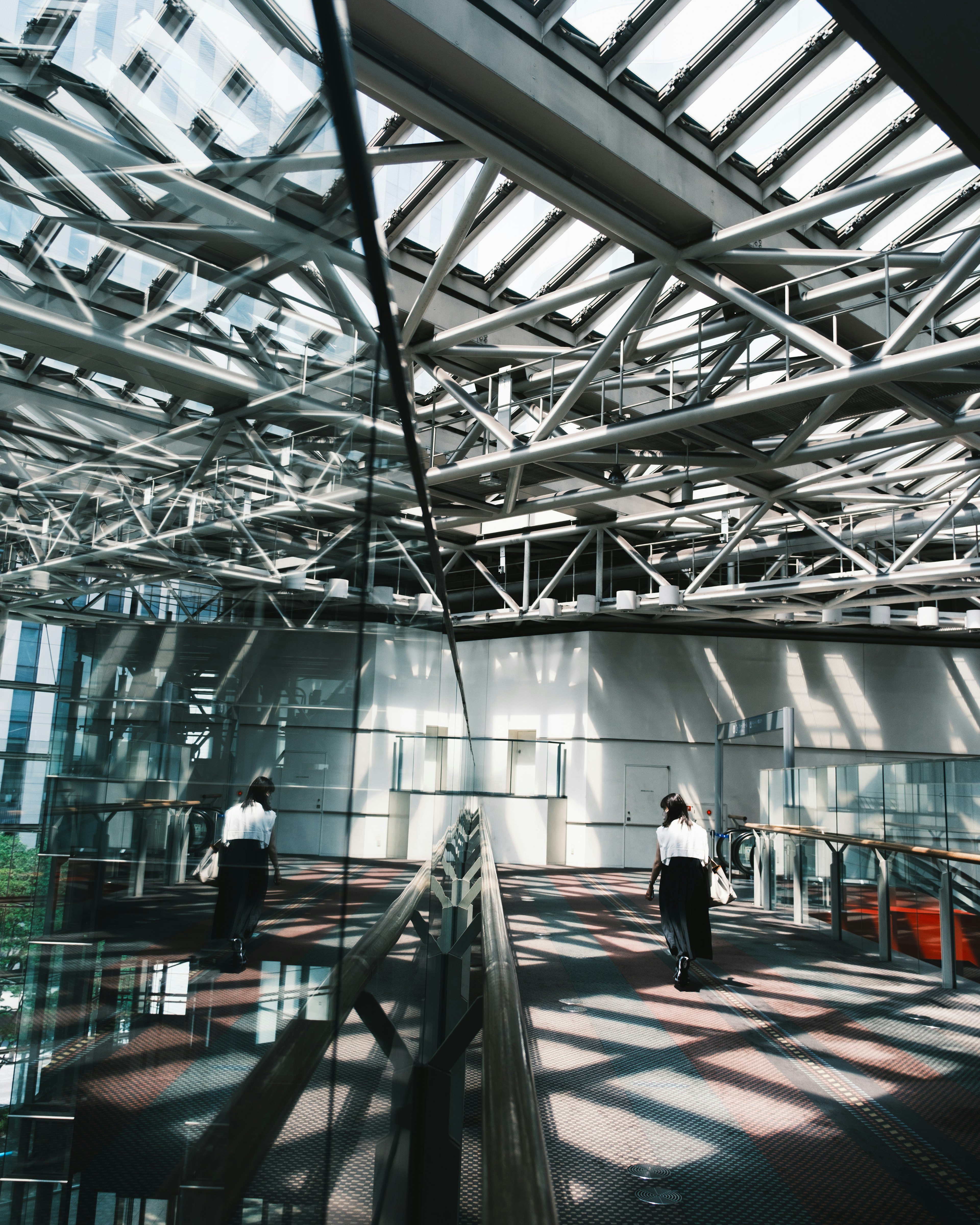 Interior of a modern building showcasing steel beams and striking light reflections