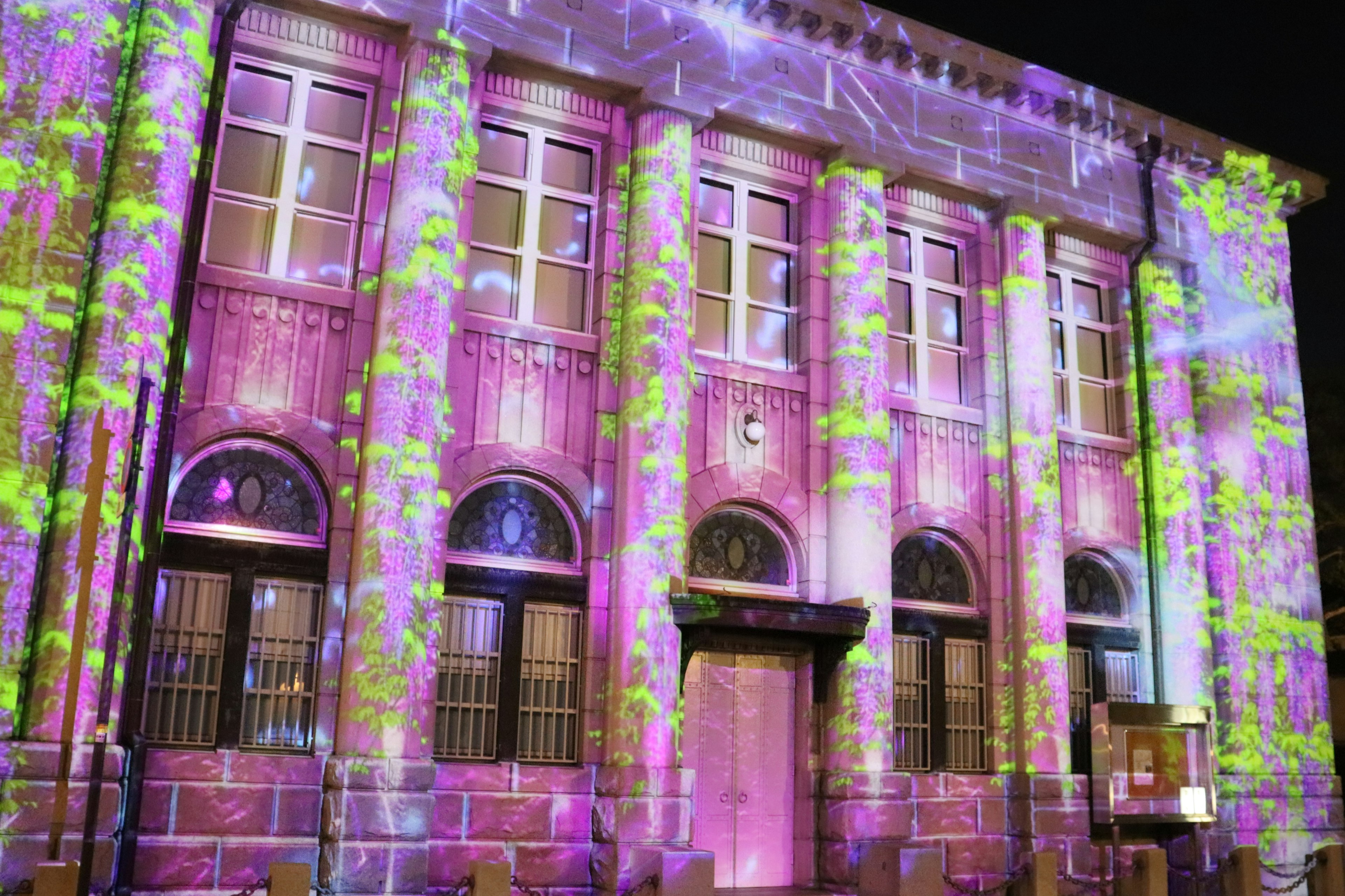 Colorful projections illuminating the facade of a building at night