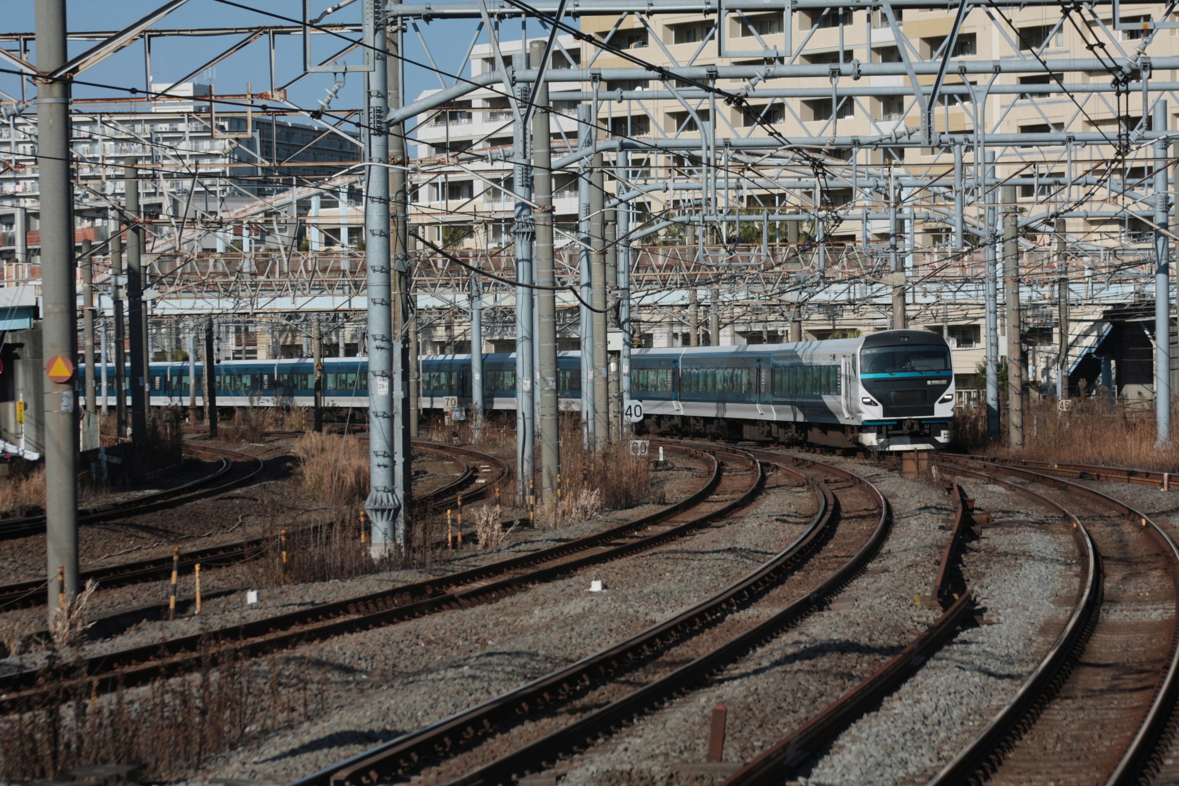 Complex railway tracks and trains intersecting in an urban setting