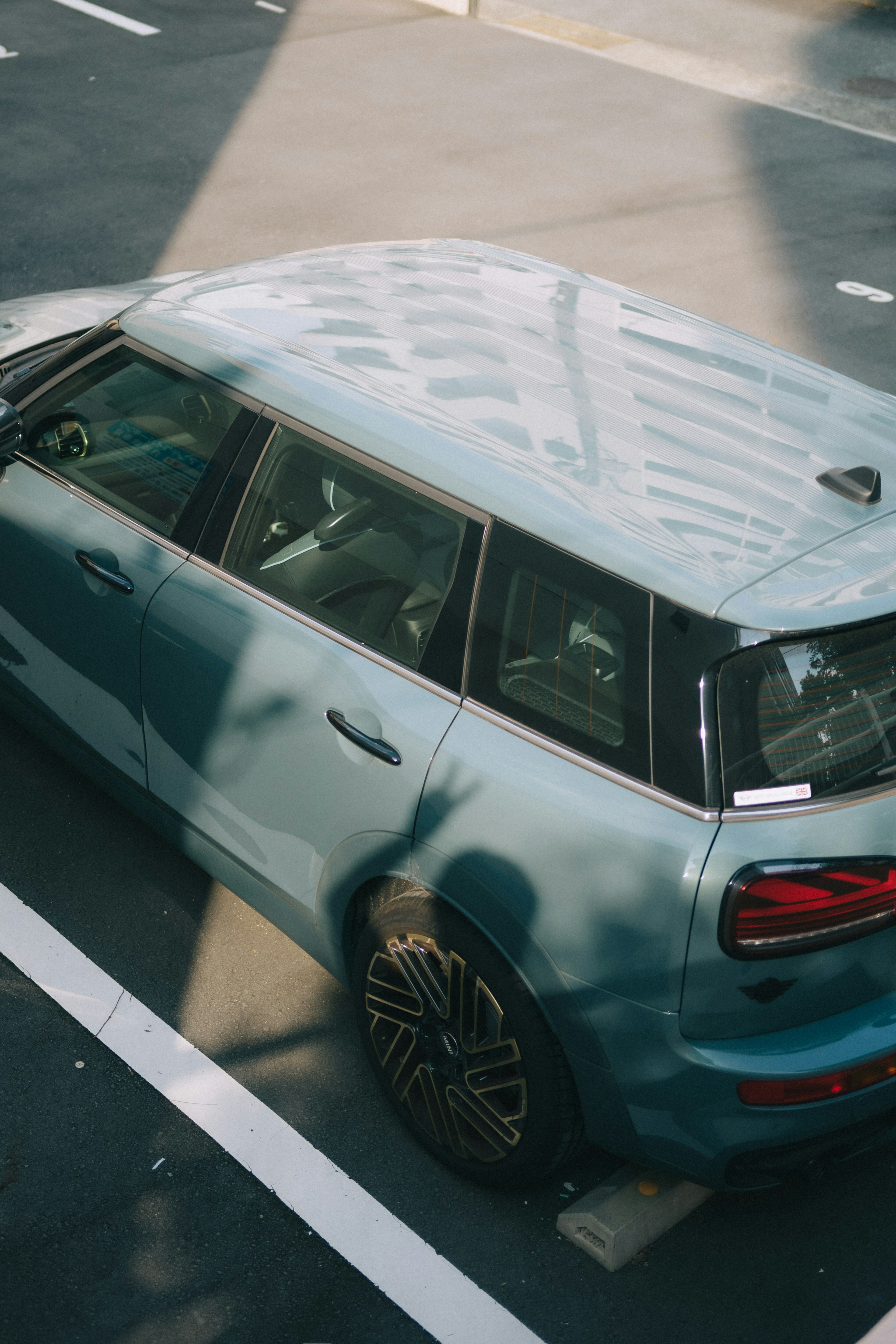 Blue SUV parked in a parking lot viewed from above