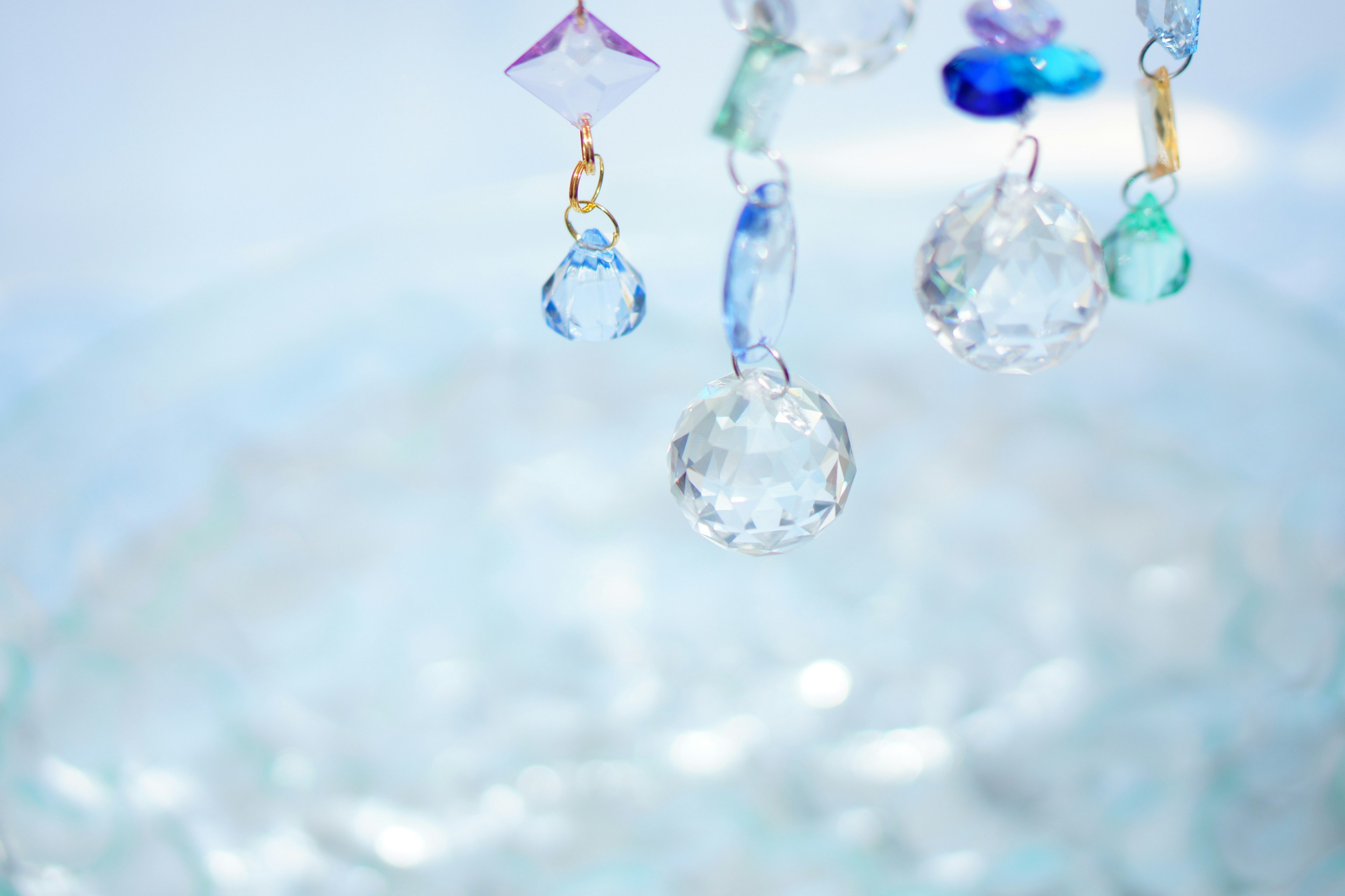 Colorful crystal ornaments reflecting on a transparent water surface