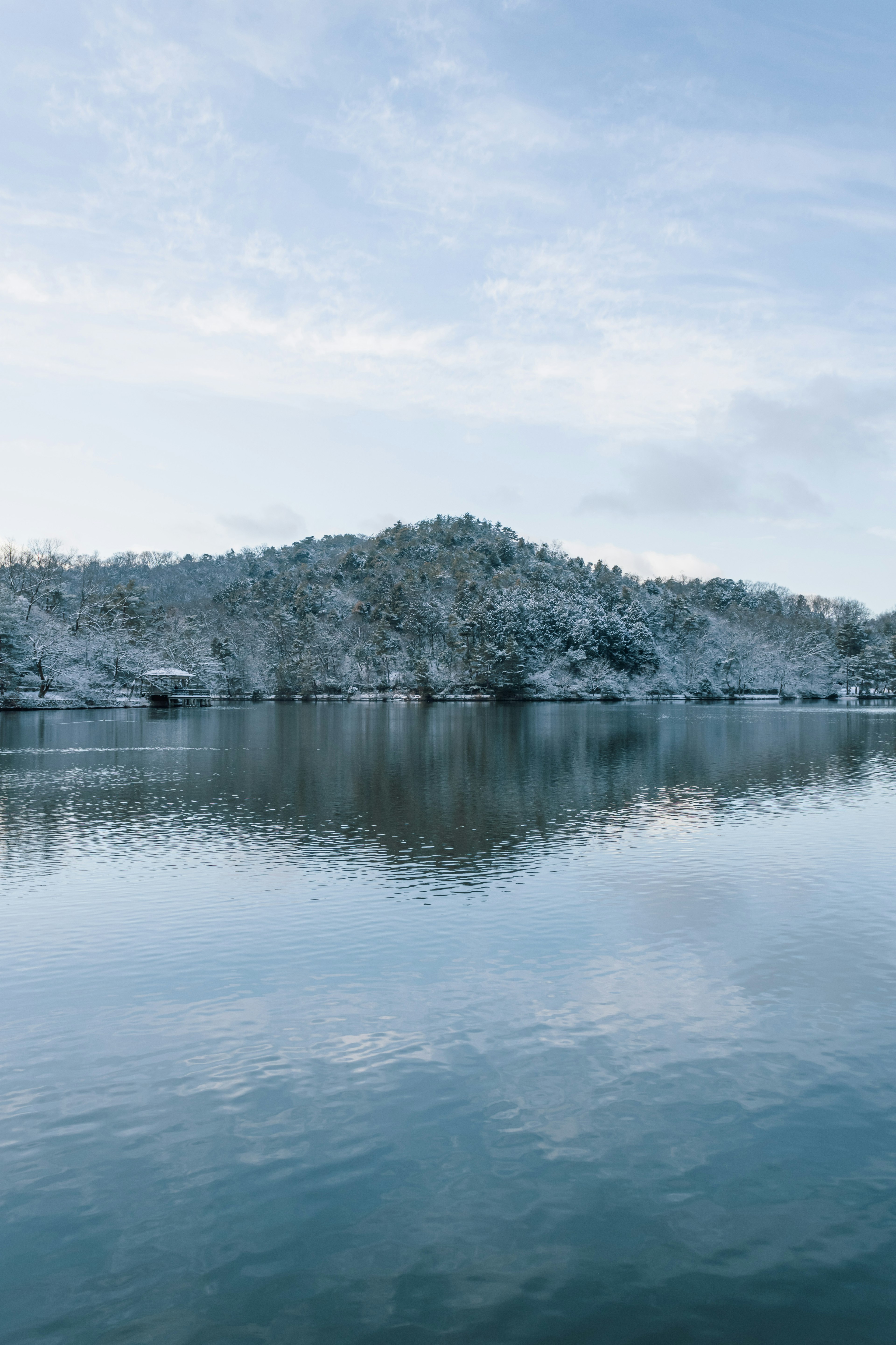 Snow-covered mountain reflecting on a calm lake